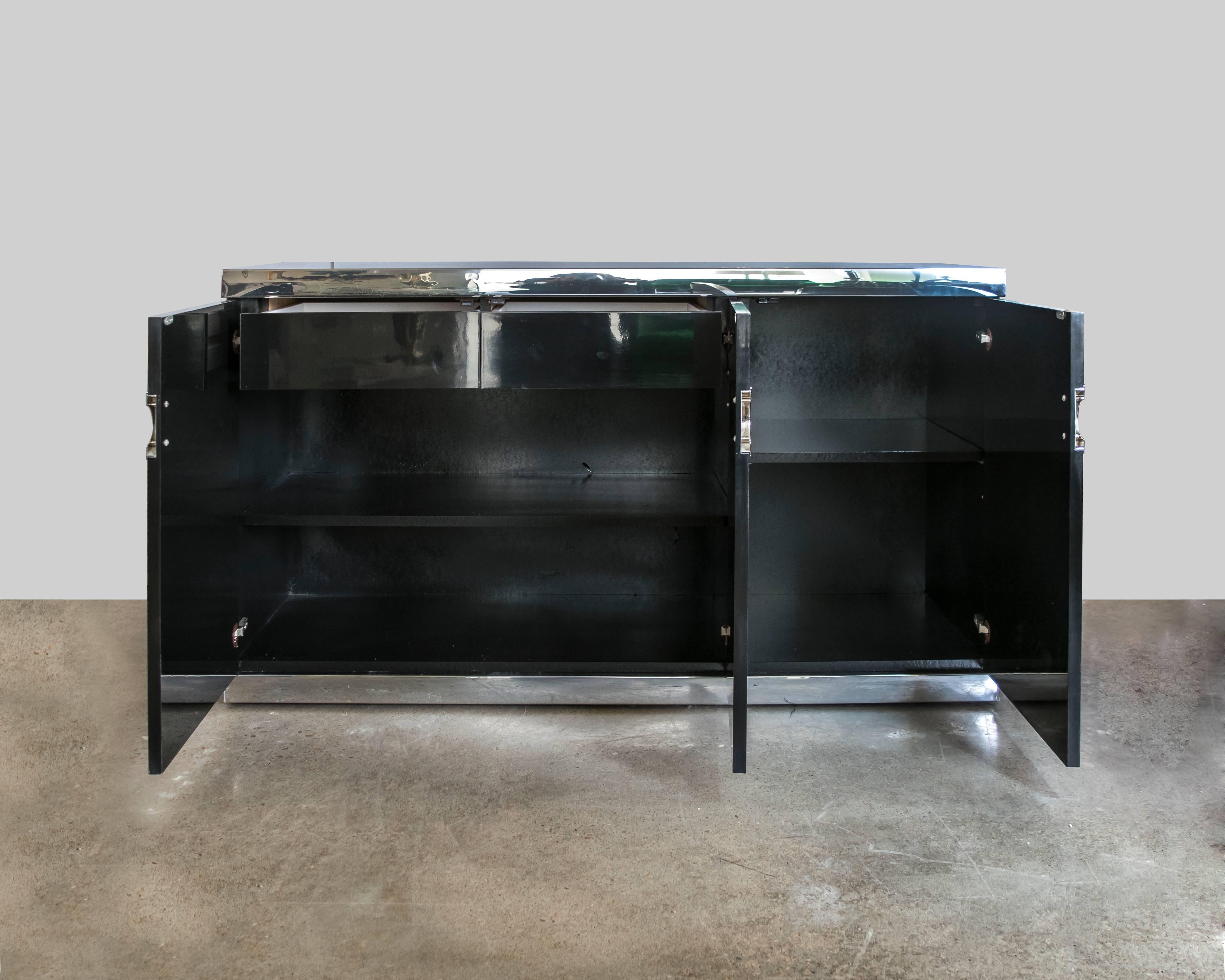 Fashion designer Pierre Cardin expanded his repertoire by adding furniture in the early 1960s which has become highly desirable. This three-door credenza in black lacquer has his characteristic broken double C hardware, complete with signature on