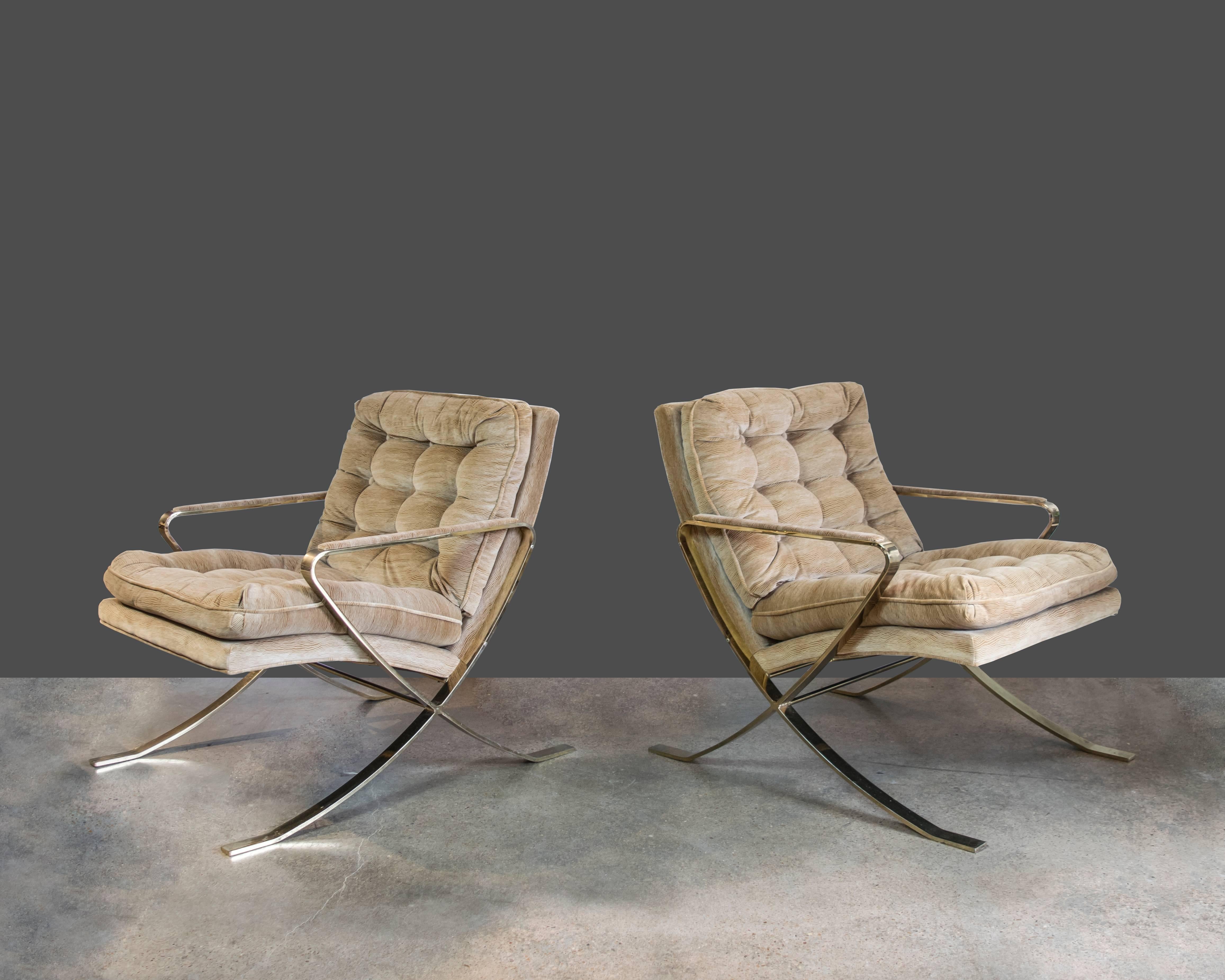 An elegant pair of scoop back and X-based brass armchairs by Milo Baughman in the original upholstery. Upholstery is clean and free of holes and spots but it is recommended that they be reupholstered.