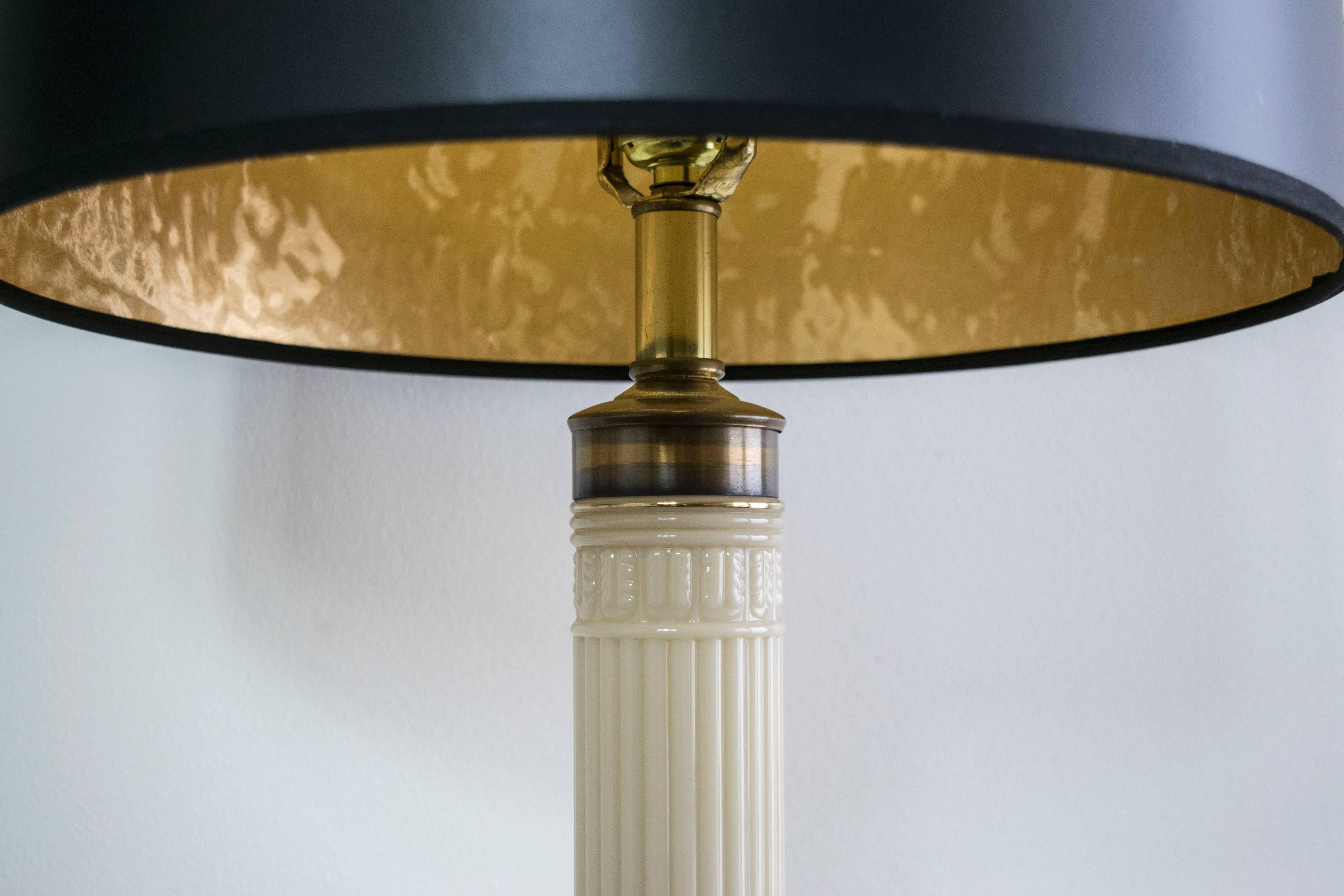 These lamps are elegantly constructed to provide dramatic highth with their Greek key brass bases and ceramic columns. They make a stately presence.