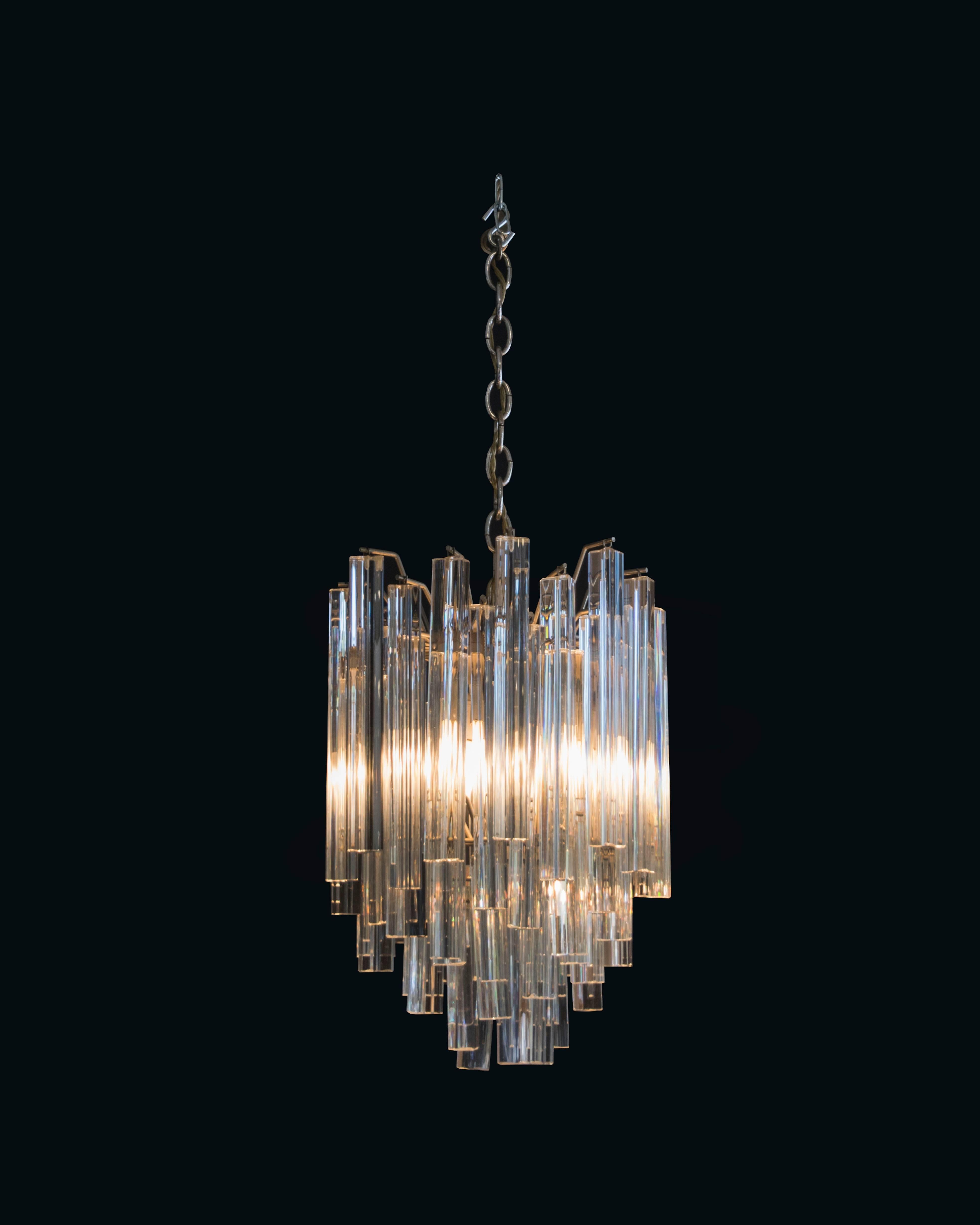 Elegant Venini chandelier with triangular crystals varying from concave to convex casting a beautiful pattern from underneath.