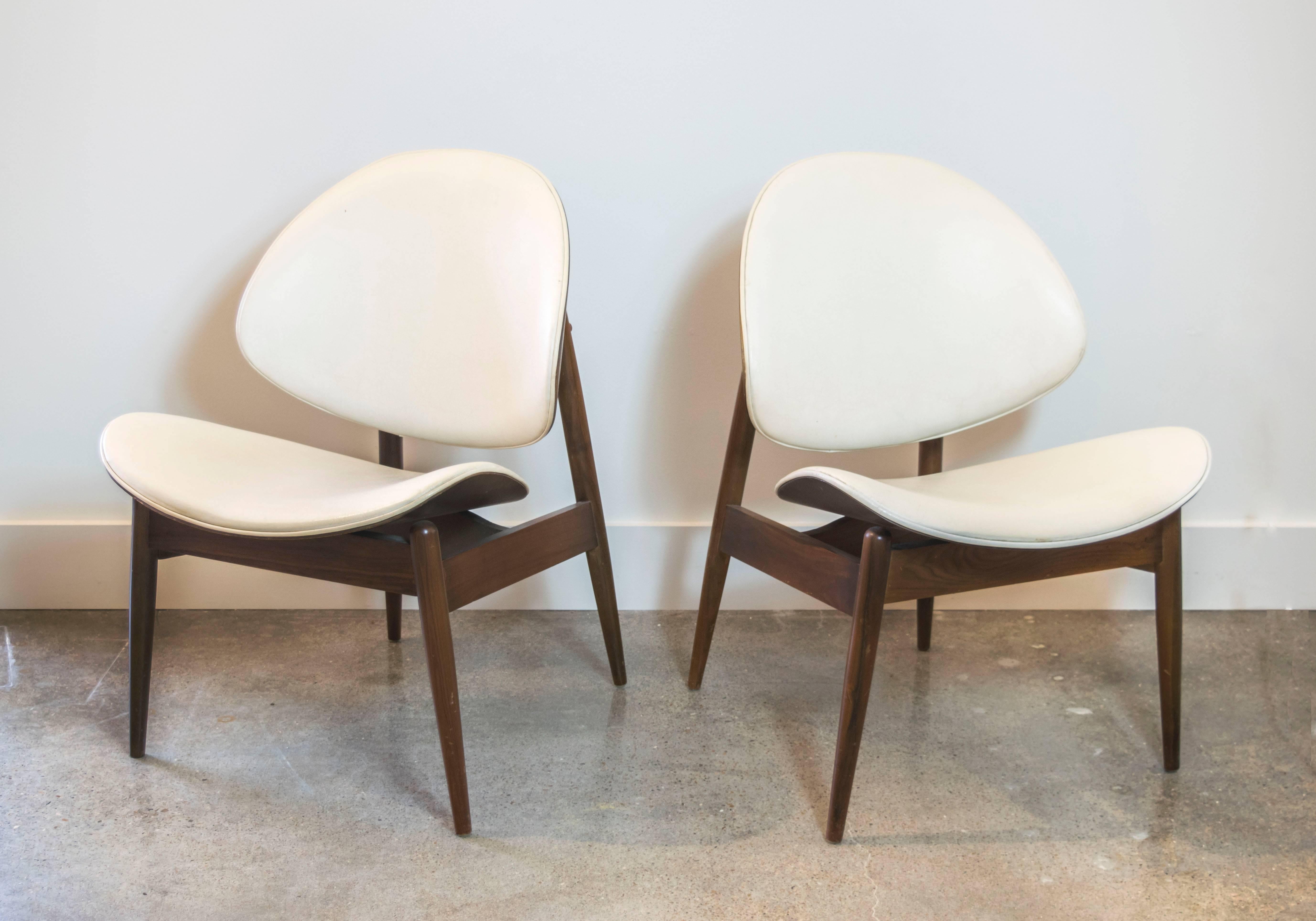 A pair of divine Mid Century classic chairs by Kodawood in the original cream vinyl. Use as is or recover. 