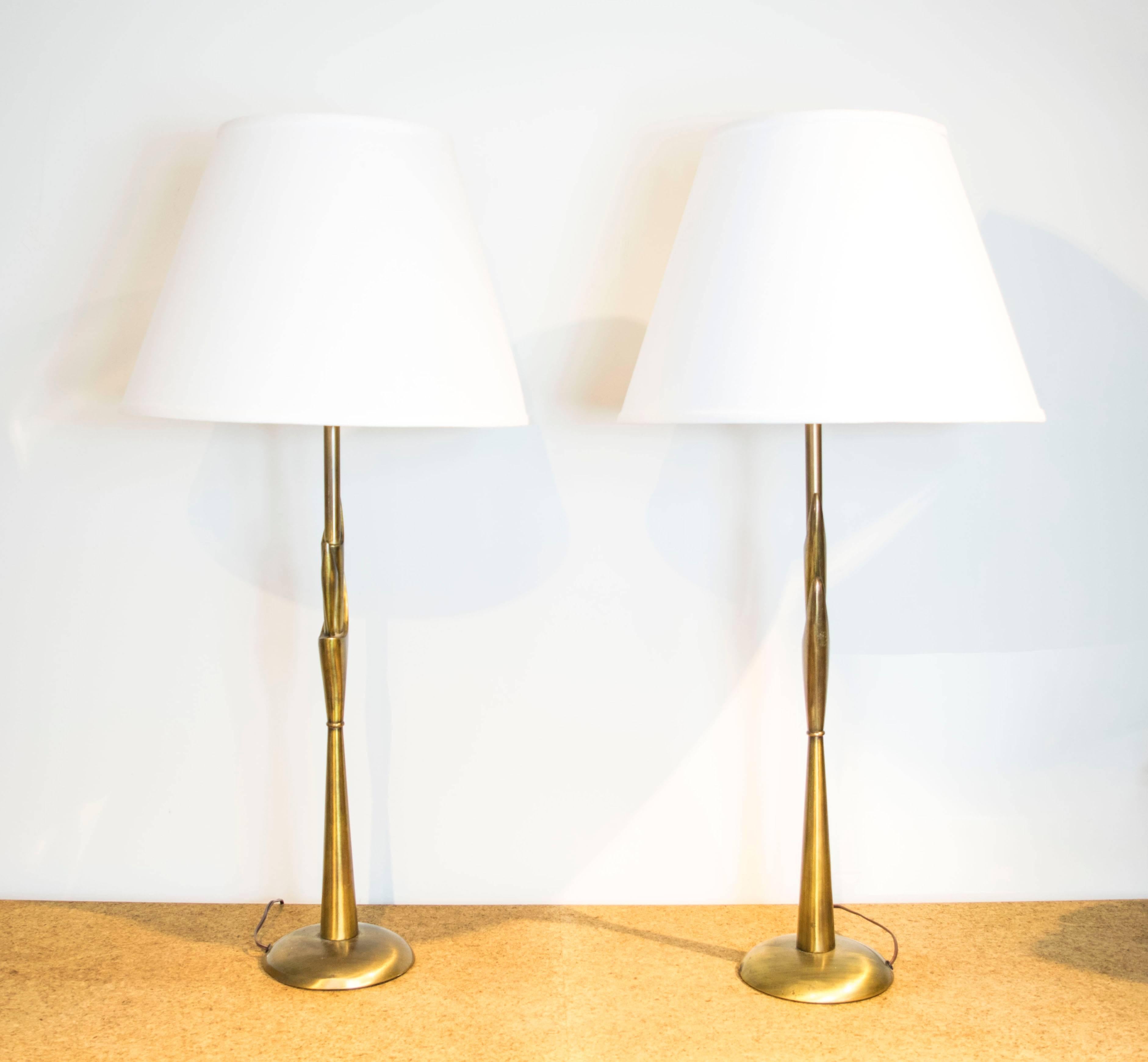 Extra tall table lamps by Rembrandt with an antique brass finish.
