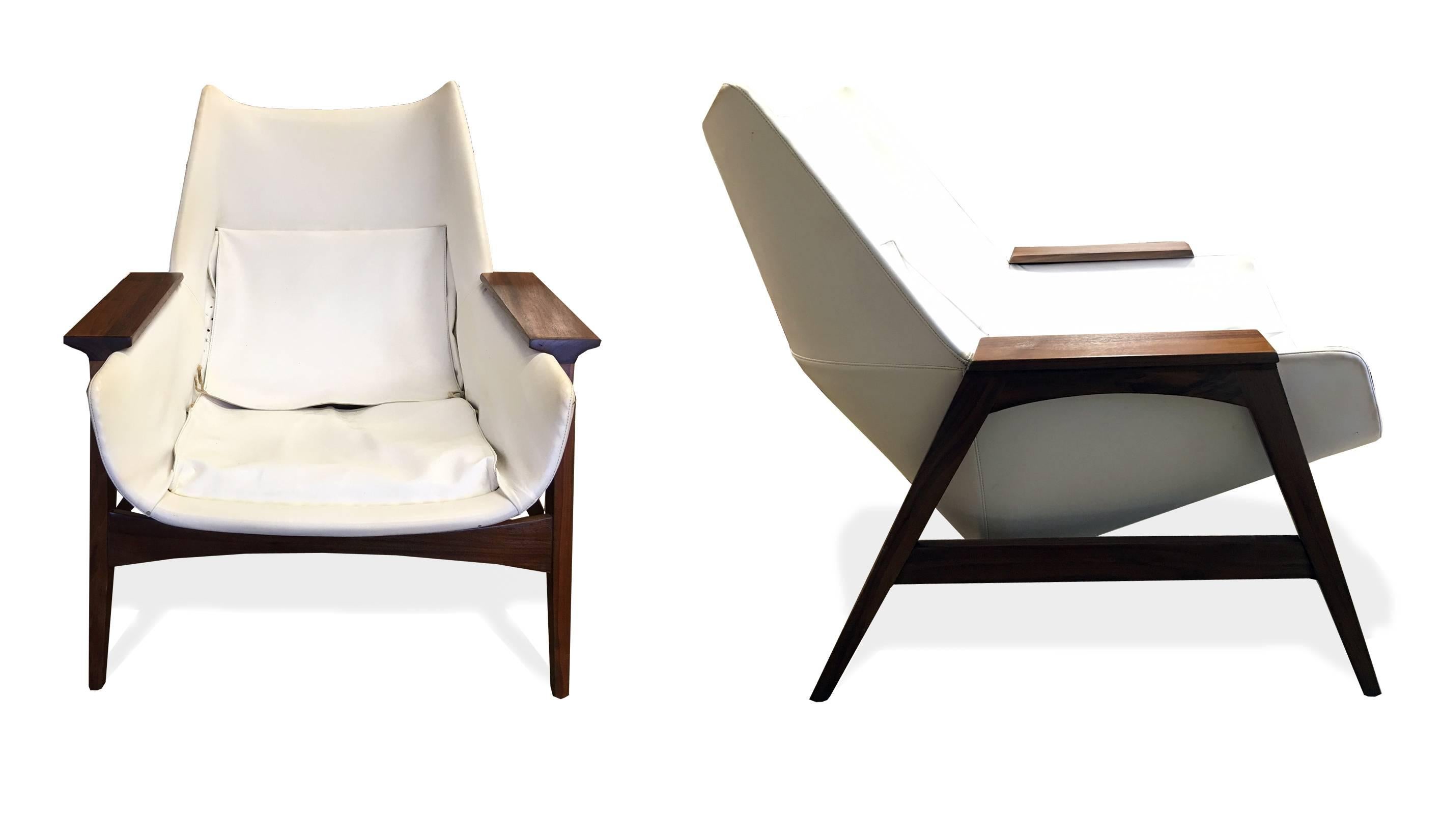Very elegant pair of arm chairs and one ottoman in the style of Ico Parisi, Circa 1964 The walnut bases have been refinished and they are currently upholstered in the original white leather