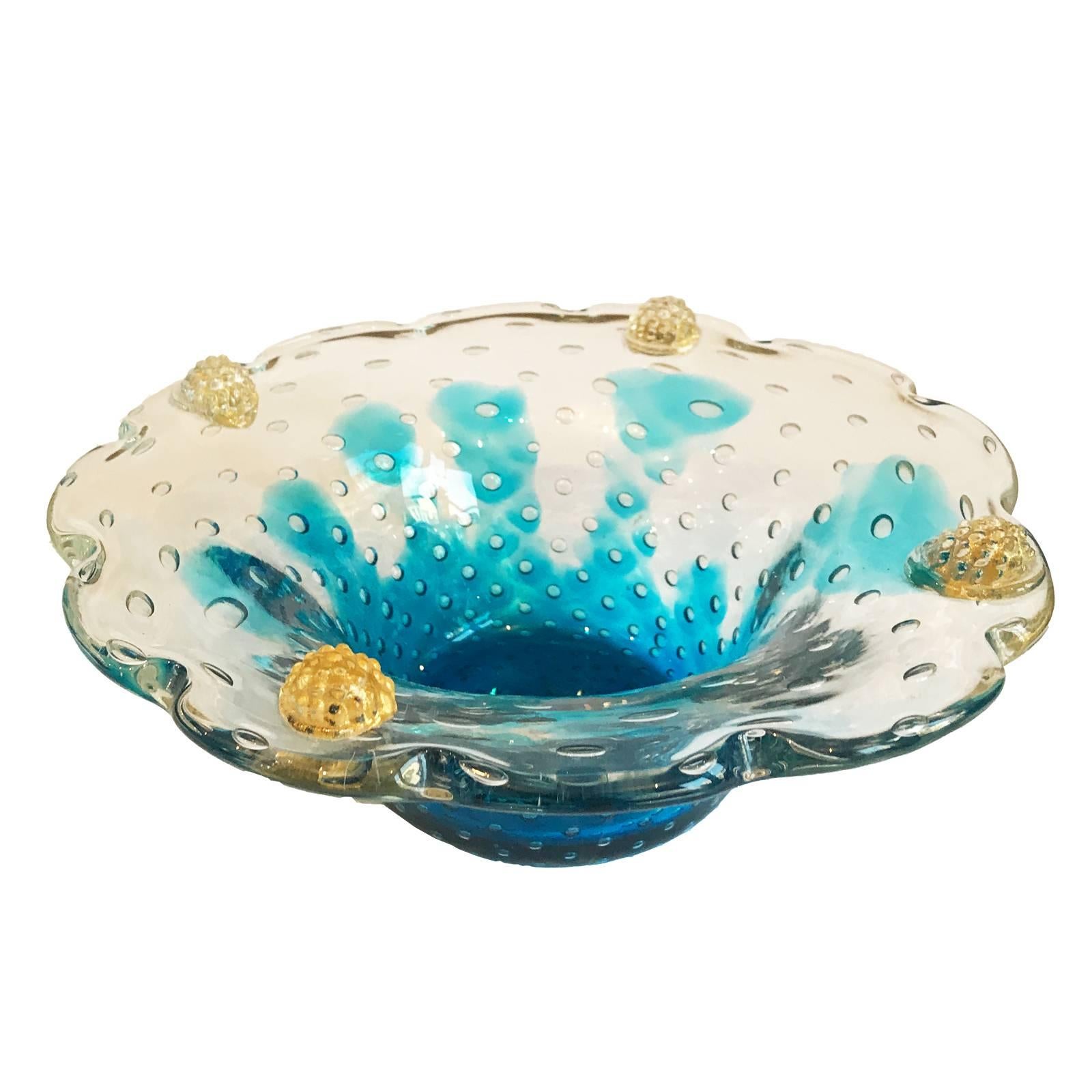 Stunning Murano centrepiece made of thick clear glass with aquamarine tones at the base. Controlled air bubbles (pulighe) are imbedded within the vitreous walls. Four applied ornaments impressed onto the glass feature embedded gold flecks and were