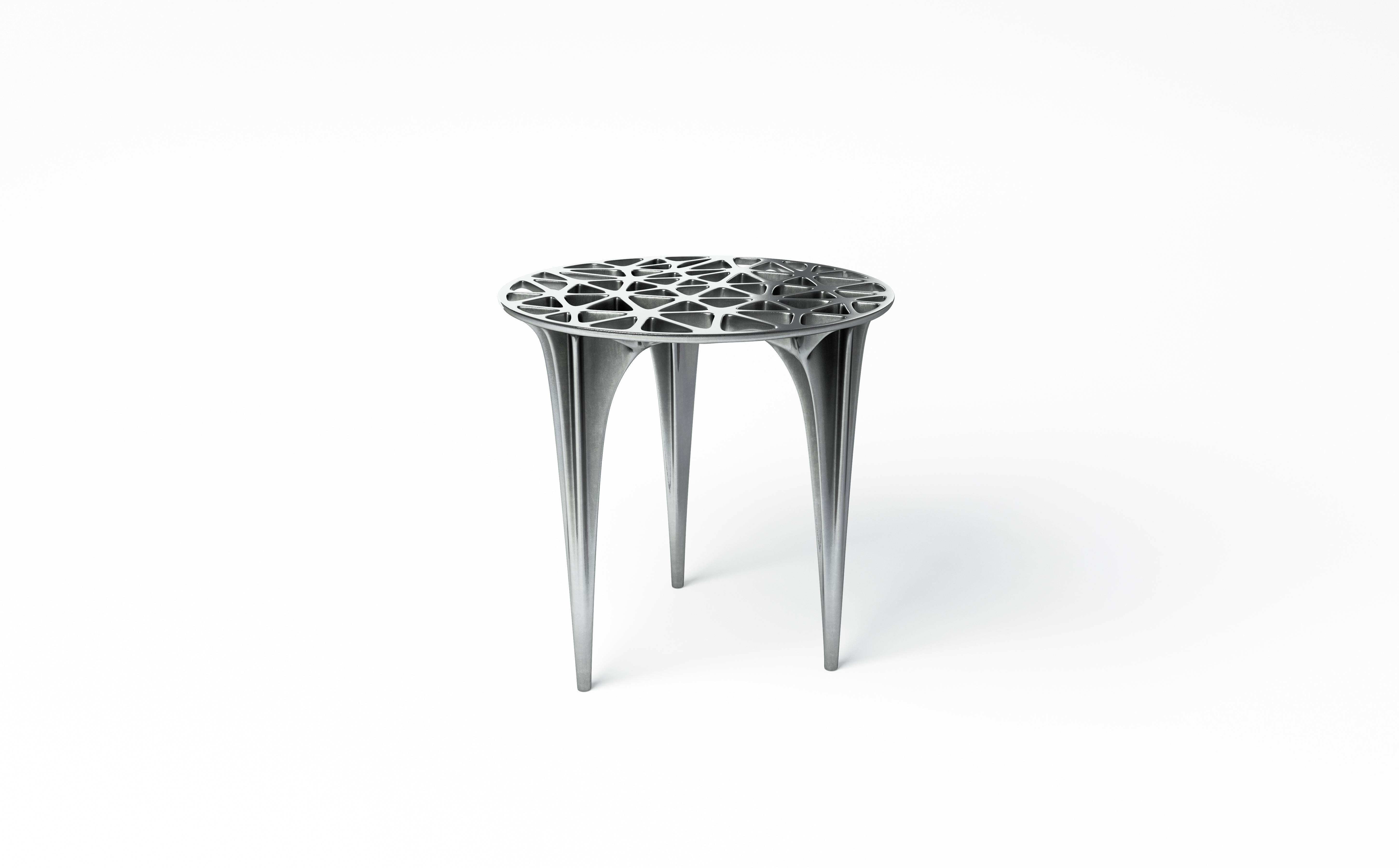 A polished aluminium side table inspired by the infamous red rocks of Sedona; the form references the peaks and plateaus of Sedona’s unique sandstone Formations. This design has a strong Silhouette and delicate, organic triangular