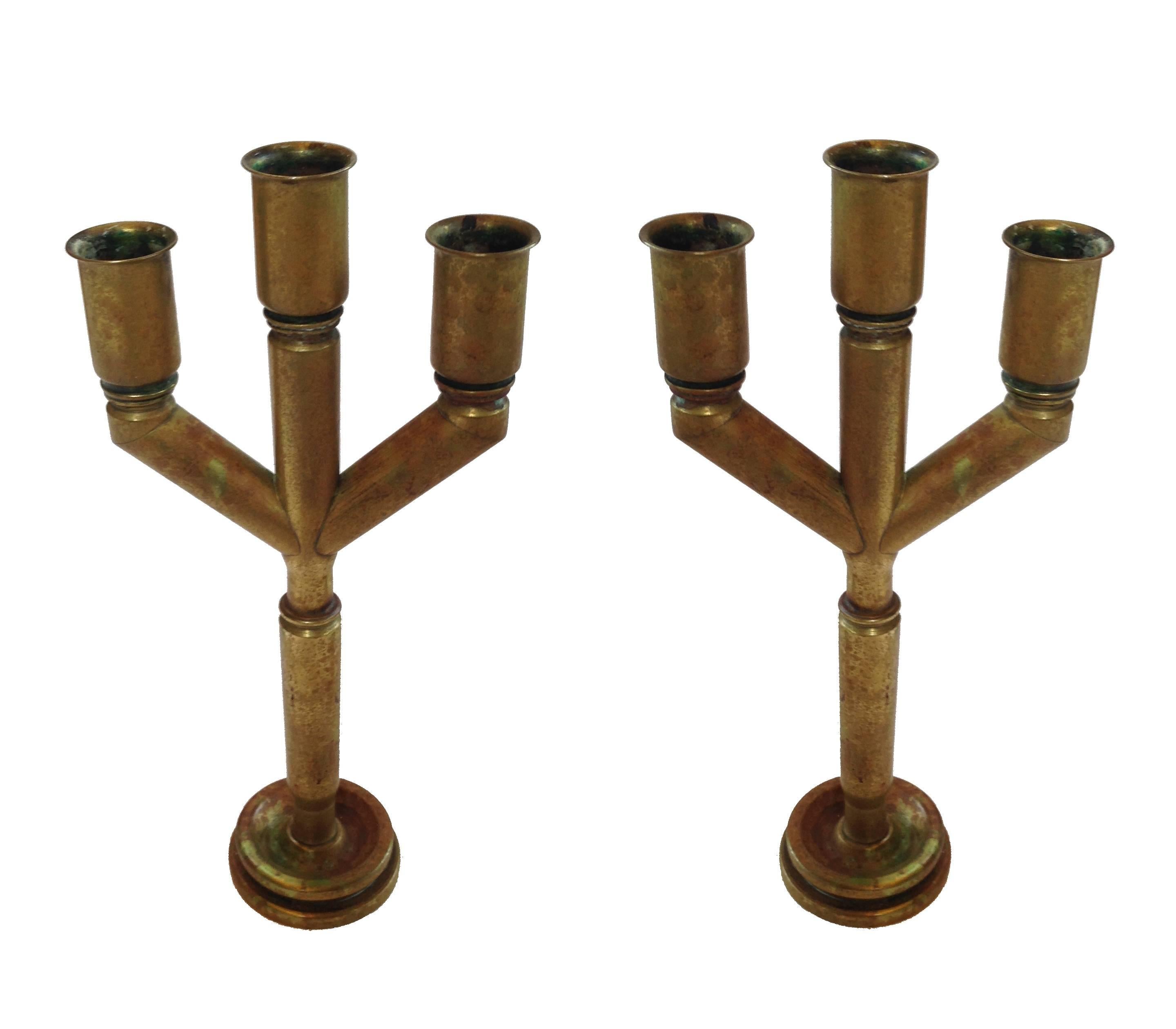 A unique pair of Trench Art candelabras or candlesticks made from solid brass shell casings. This particular design is rather unusual.