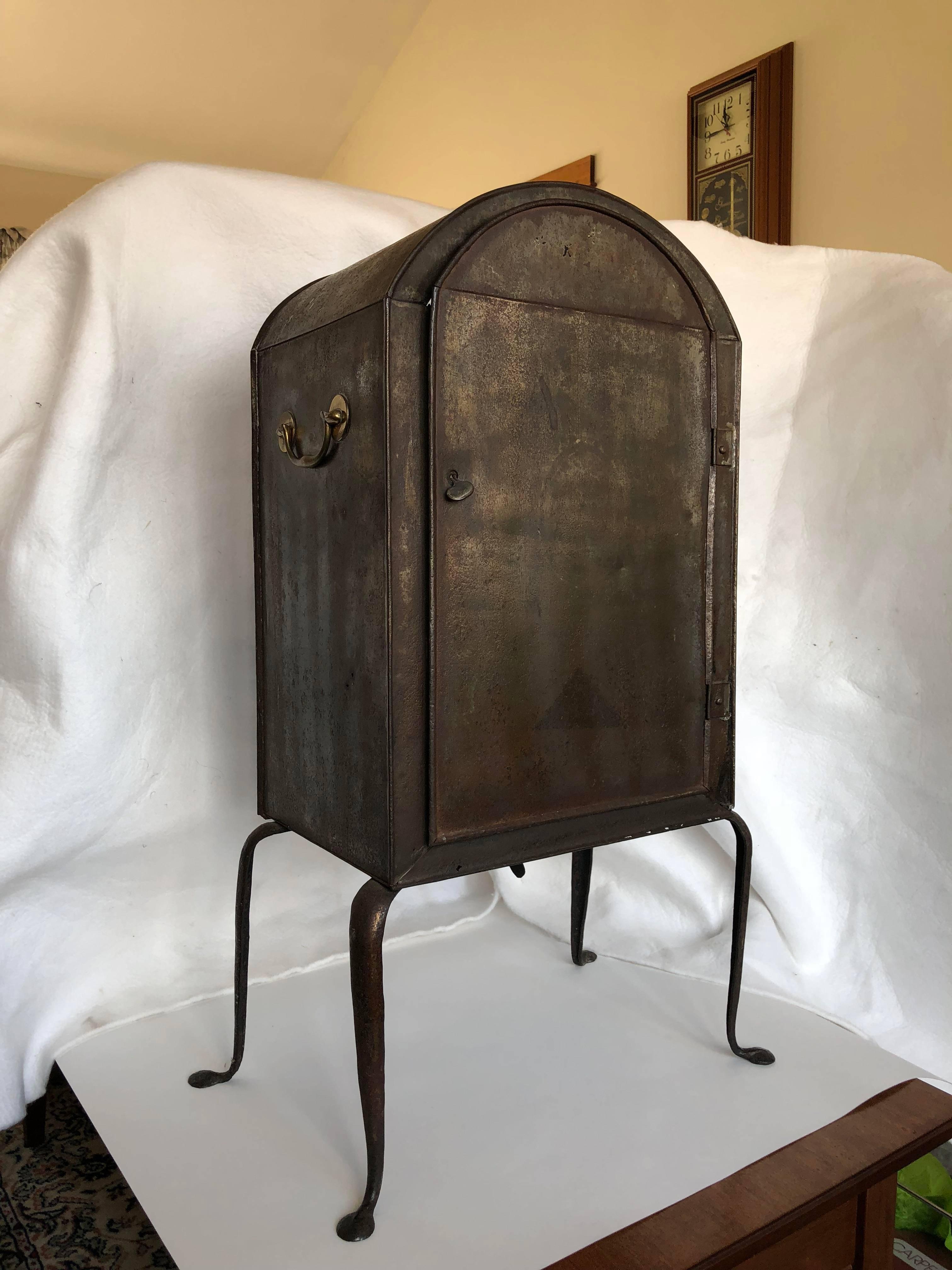 English Georgian period arch top plate warmer with brass handles, circa 1820. This piece would have originally been painted (tole), and is now polished metal.