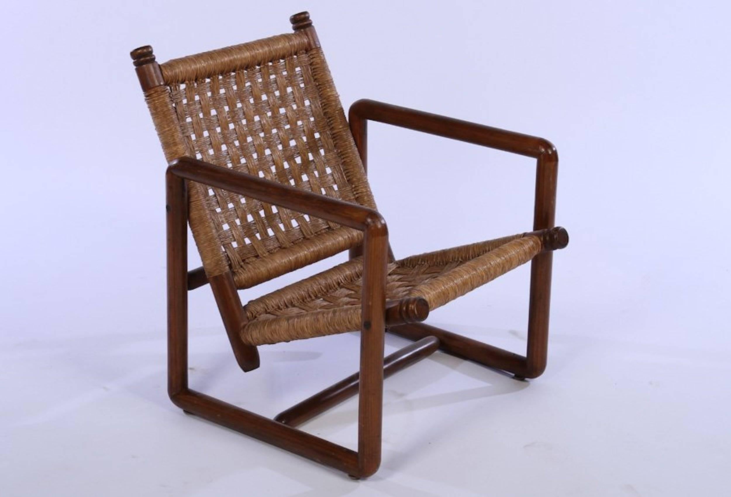 Pair of French woven rush lounge chairs having open grid Rush backs and seats supported by rectilinear frame circa 1960. 

Dimensions: 26.5" H x 25" W x  26" D