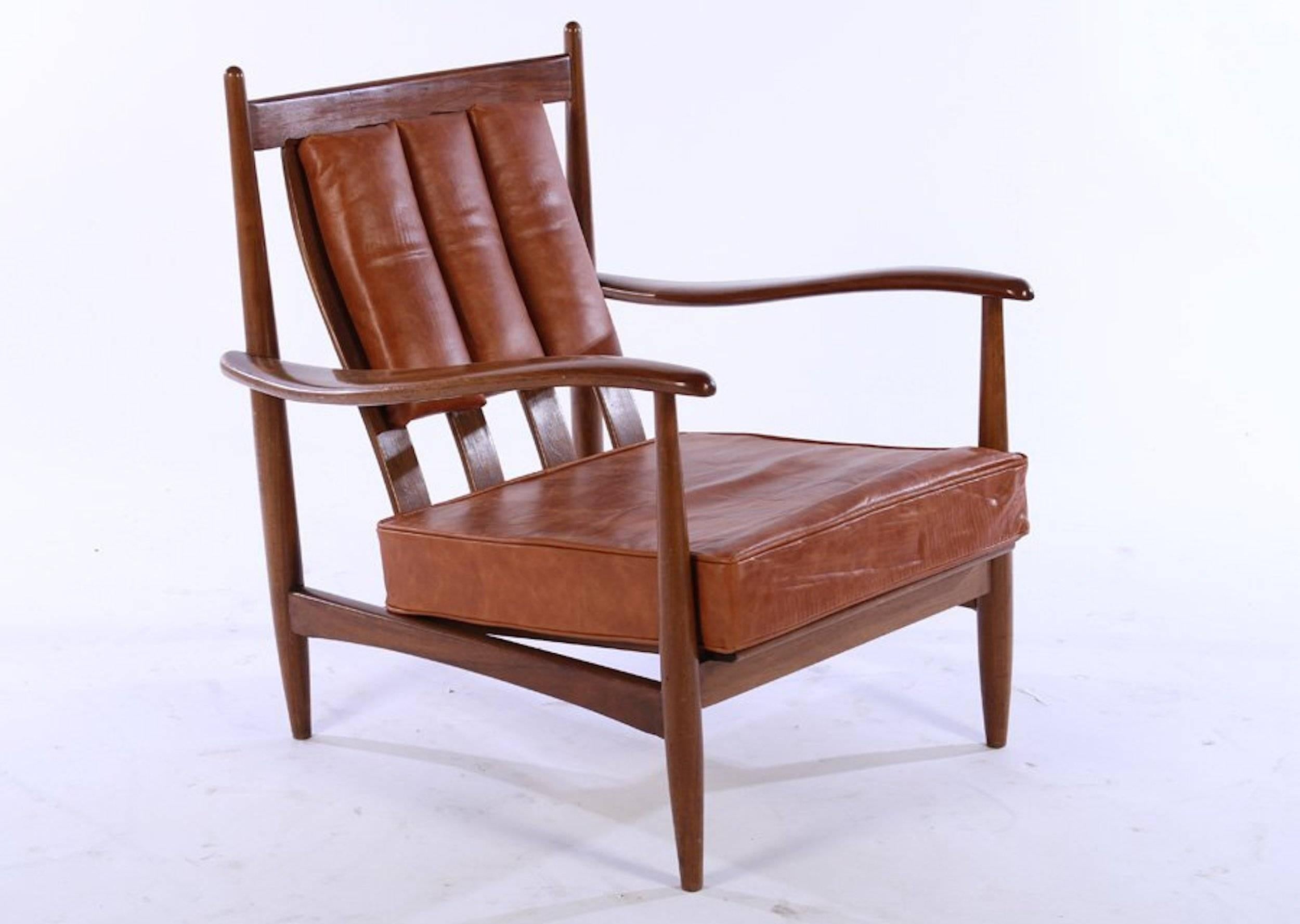 A pair of Danish channeled leather lounge chairs with walnut frames and loose seat cushions, circa 1960. 

Dimensions: 32
