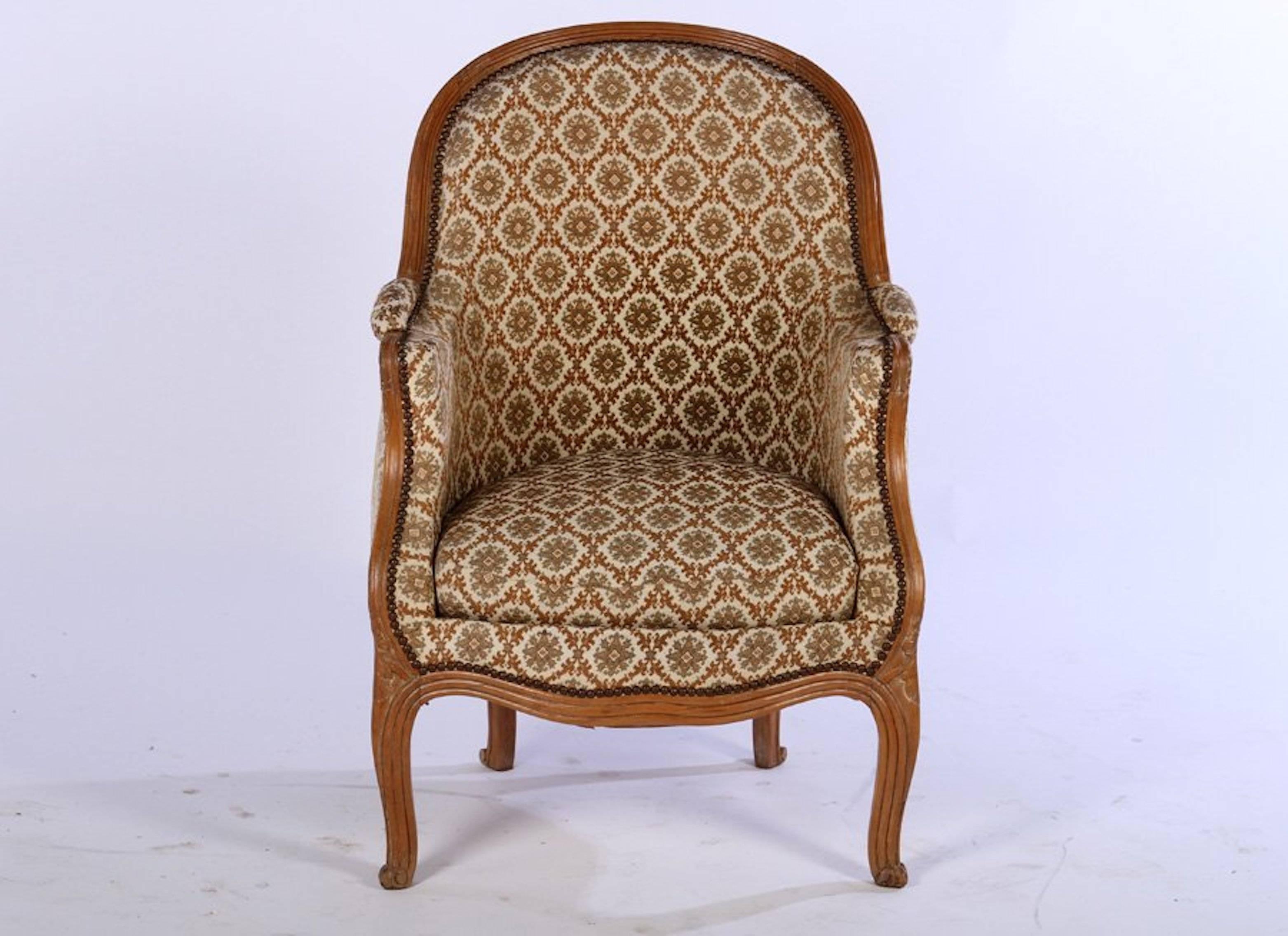 An Art Deco Period French Louis XV style bergere having carved and arched back over downswept arms above a loose seat cushion raised on cabriole legs.

 