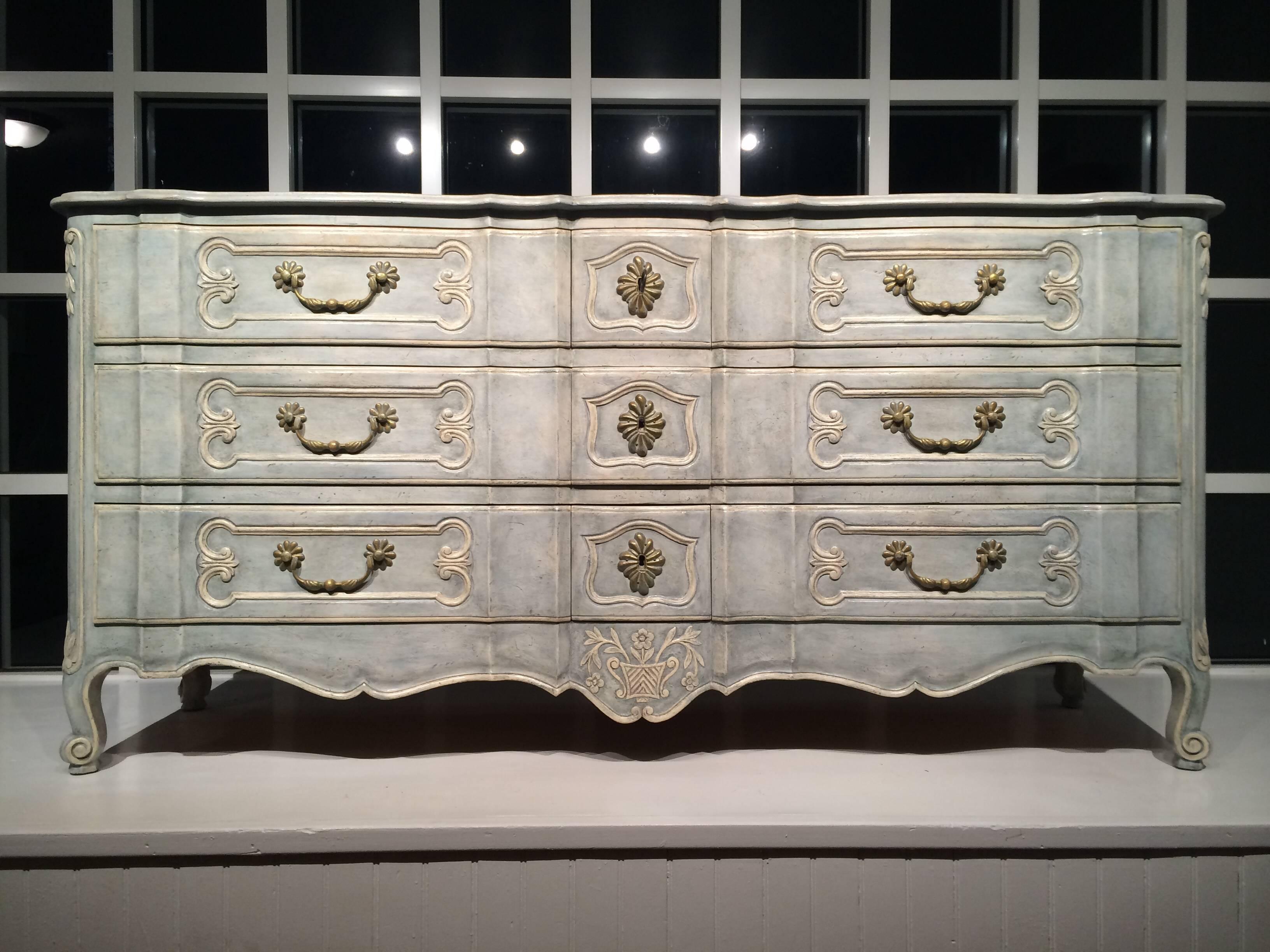 French style chest; branded "Don Rousseau, New York." 

Carved and painted frame containing nine drawers (three lockable centre drawers with three drawers on either side) raised on cabriole legs.