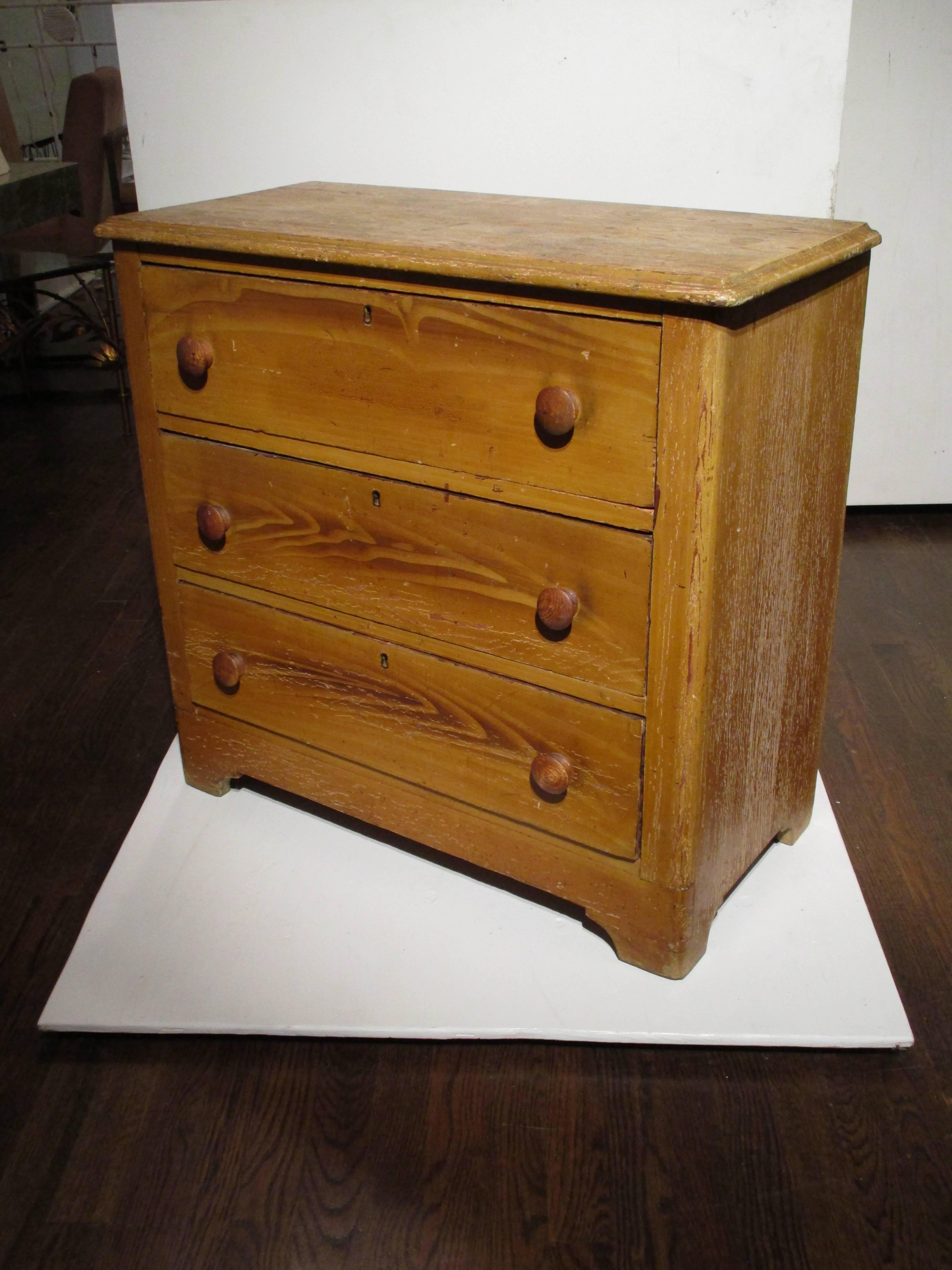 A 19th century grain painted three drawer chest. Eastport, NY.