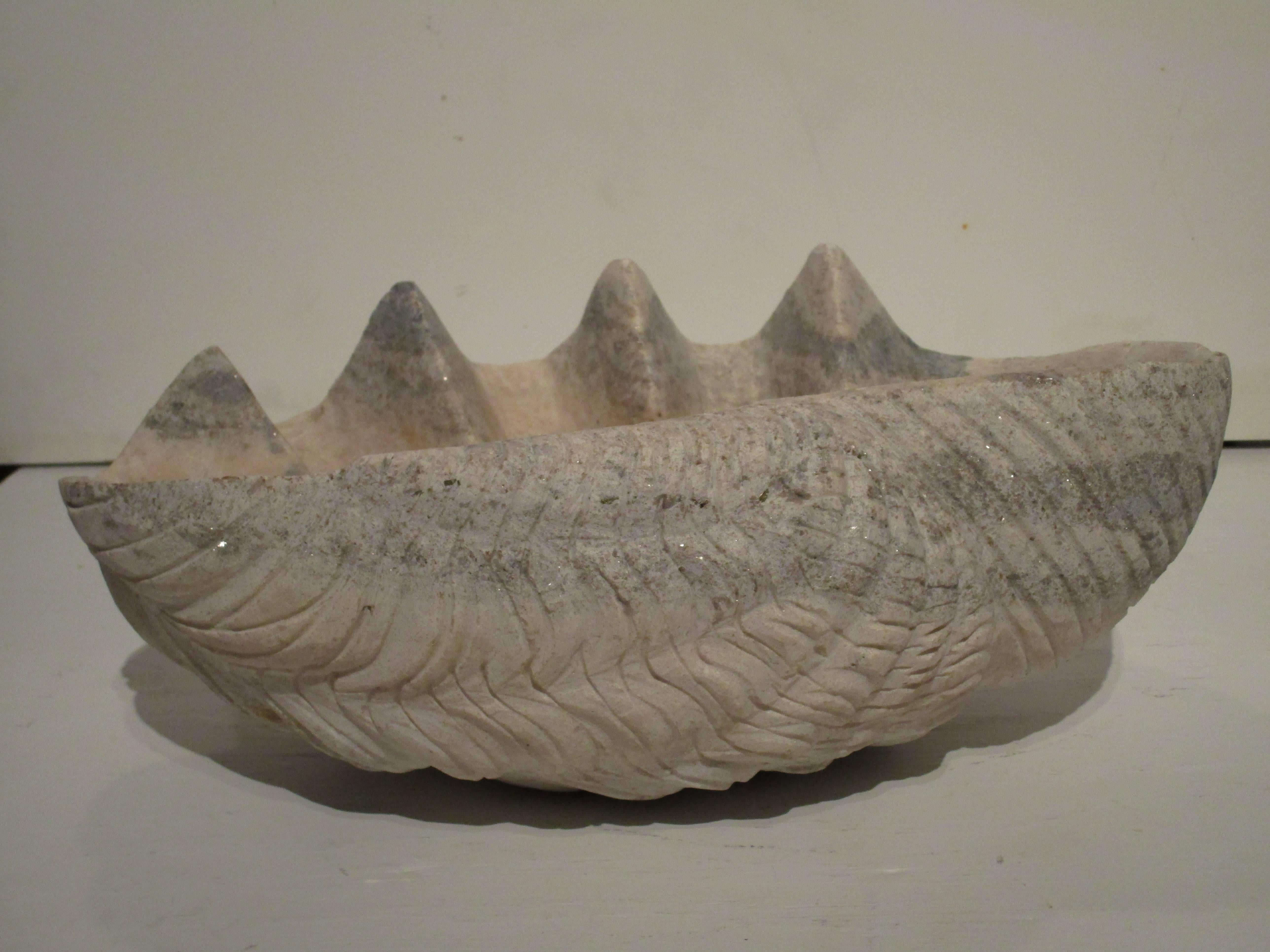 Large clam shell sculpture carved from stone.