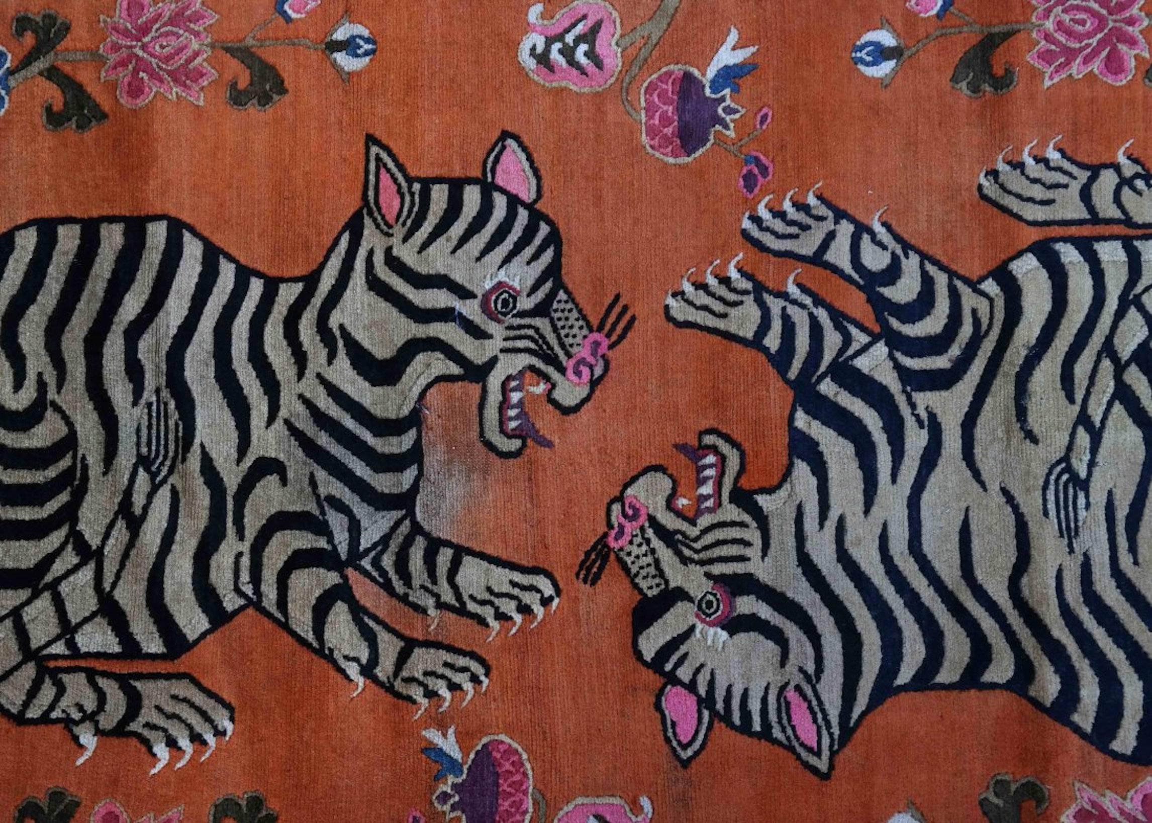 Tibetan rug depicting playful tiger cubs. 

Dimensions: 68