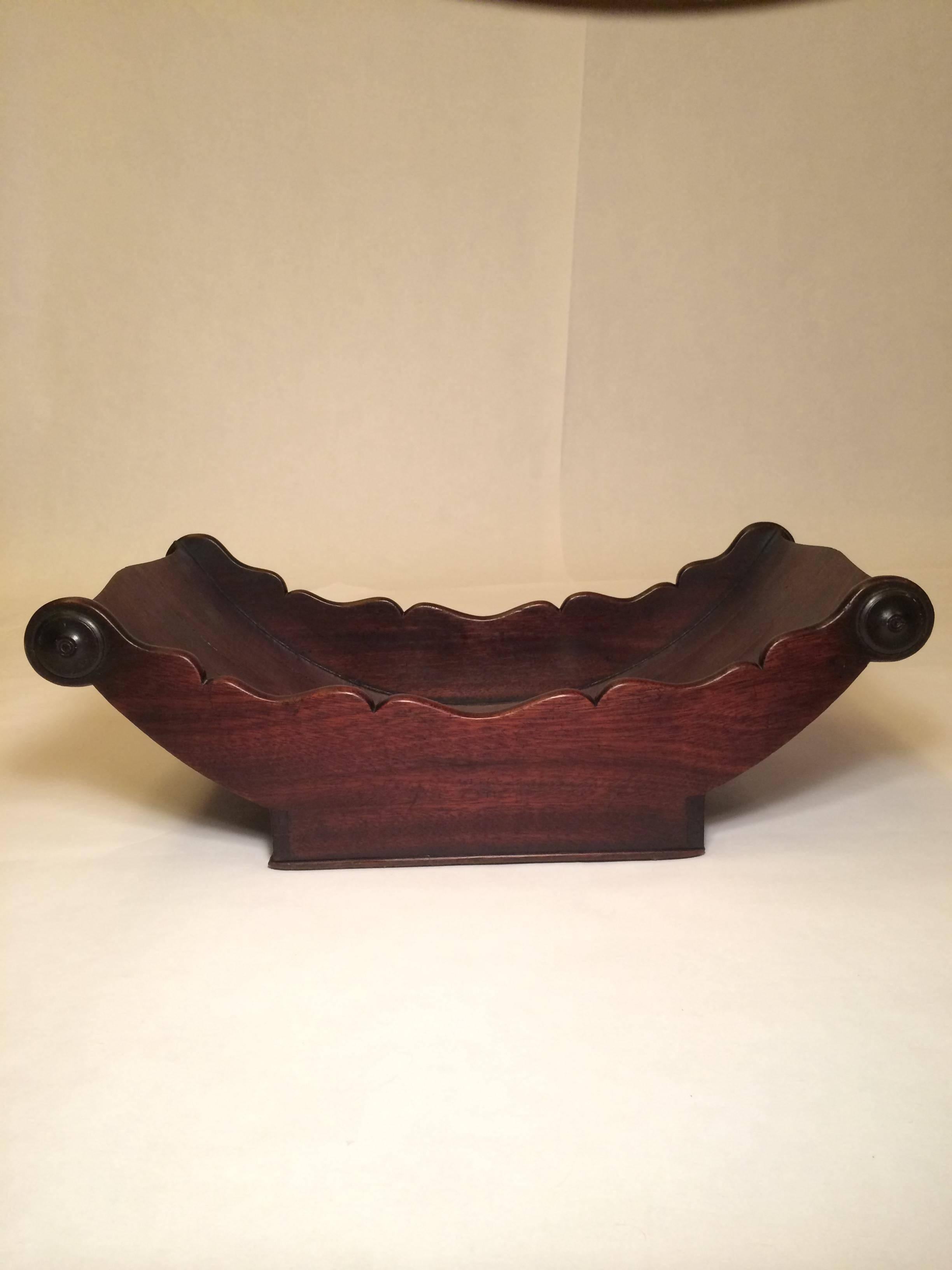 Mahogany cheese coaster, England, circa 1800. Turned half baluster ends and carved roundels.
