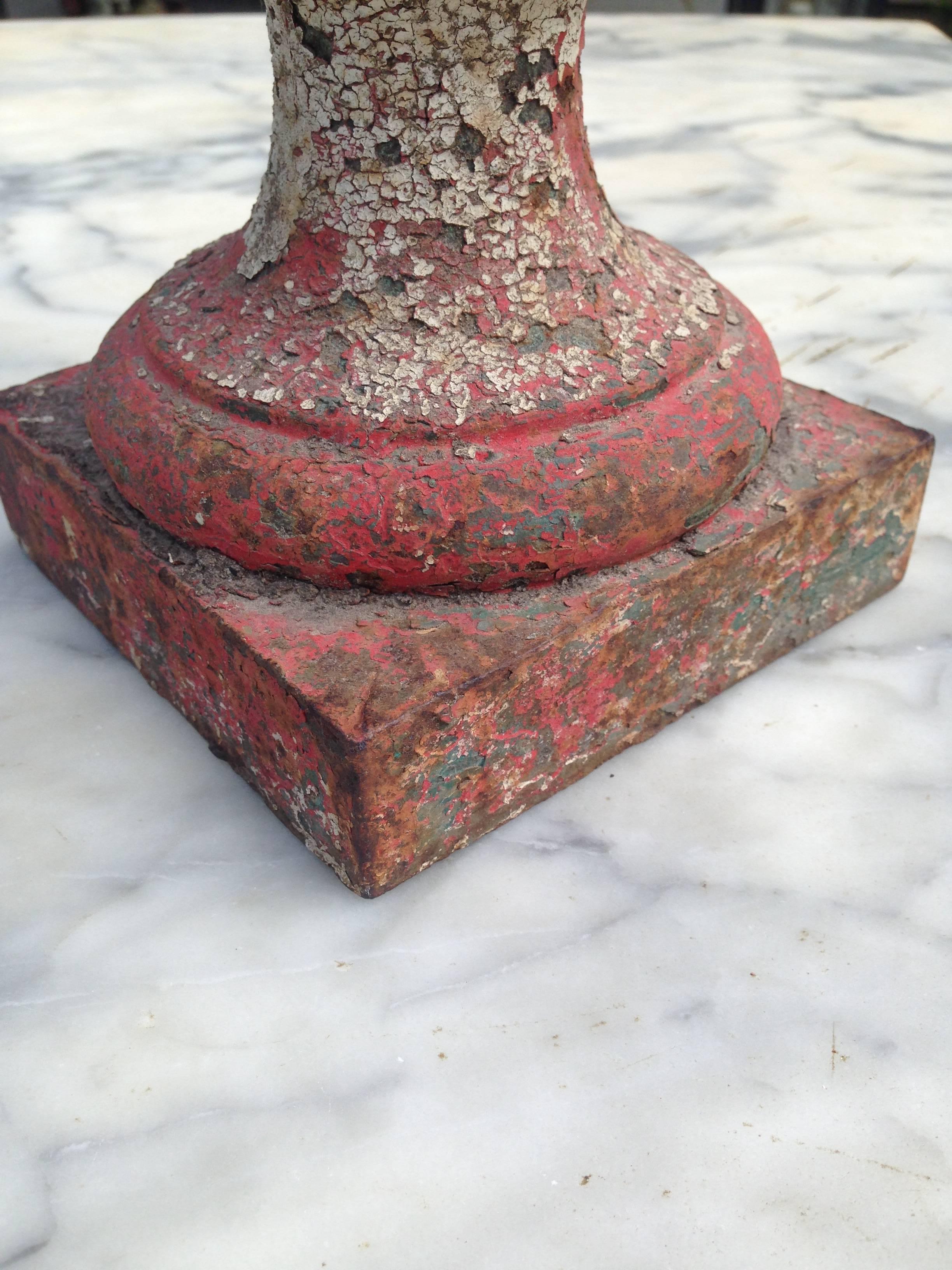 A French cast iron garden urn showing several layers of old paint (red, blue and white). Suitable for the garden or interior. 
