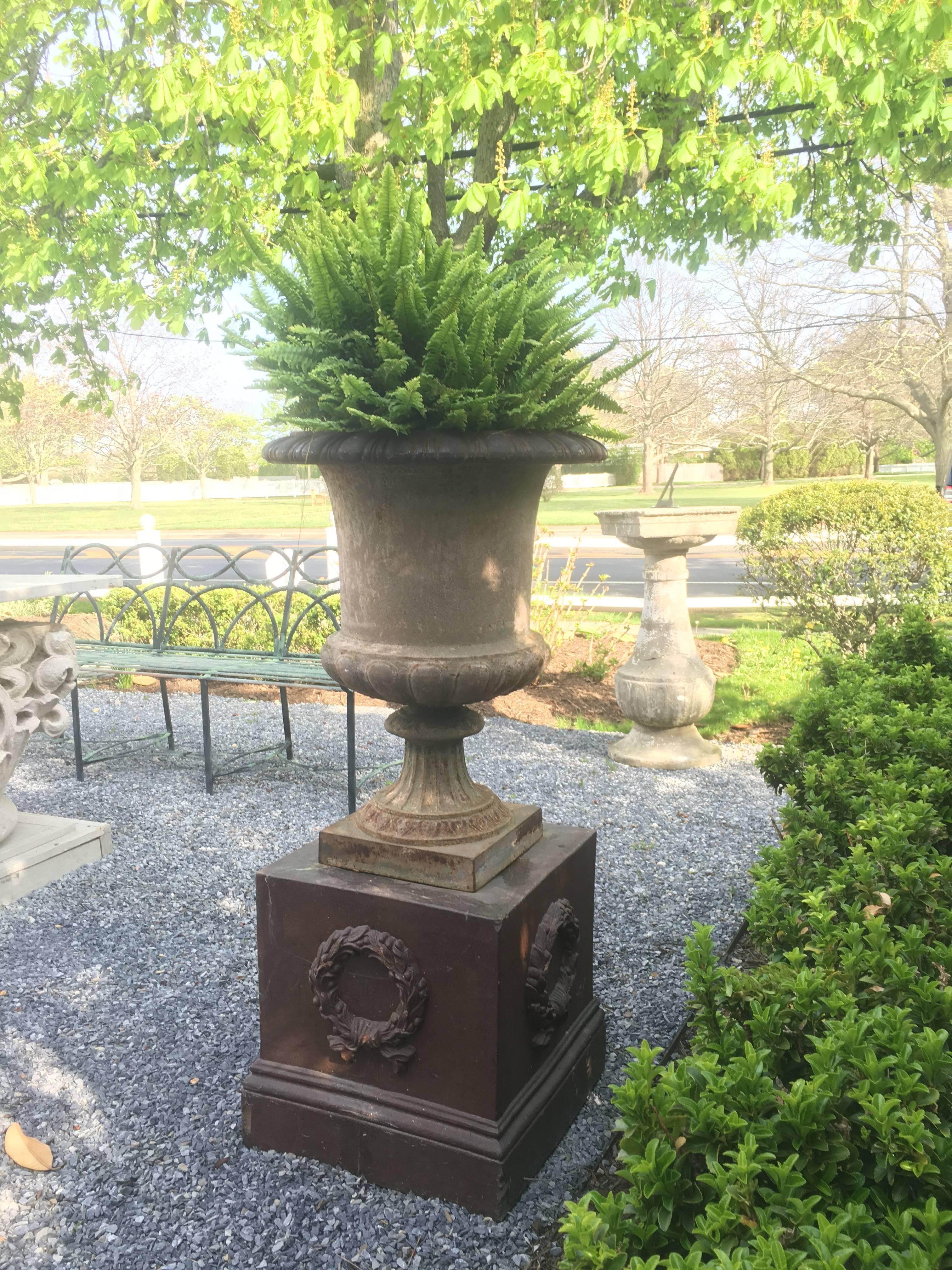 French cast iron garden urn on Portland (Maine) Stoneware Co. Base, both 19th century.

Dimensions
Overall: 46