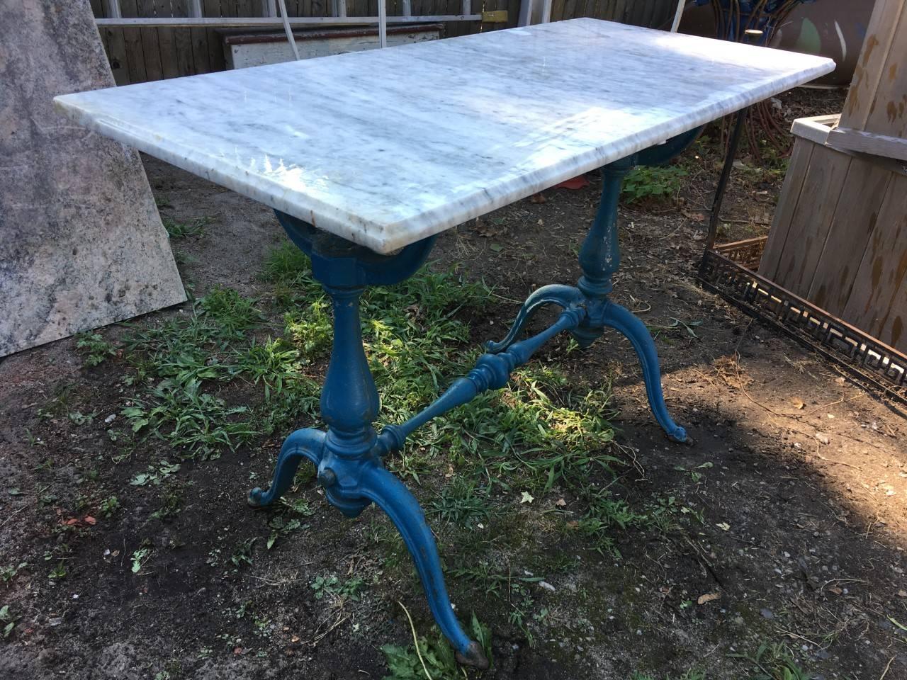 French blue painted cast iron table; baluster form support and stretcher, spade feet with removable marble top; France, 1910. *This table was most likely originally intended as a bistro table or bakers table. 