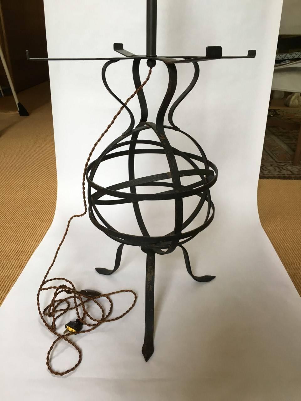 Table lamp, circa 1950.   Strap iron in the form of orb, double cluster light socket newly rewired with silk wrapped cord and cord switch.