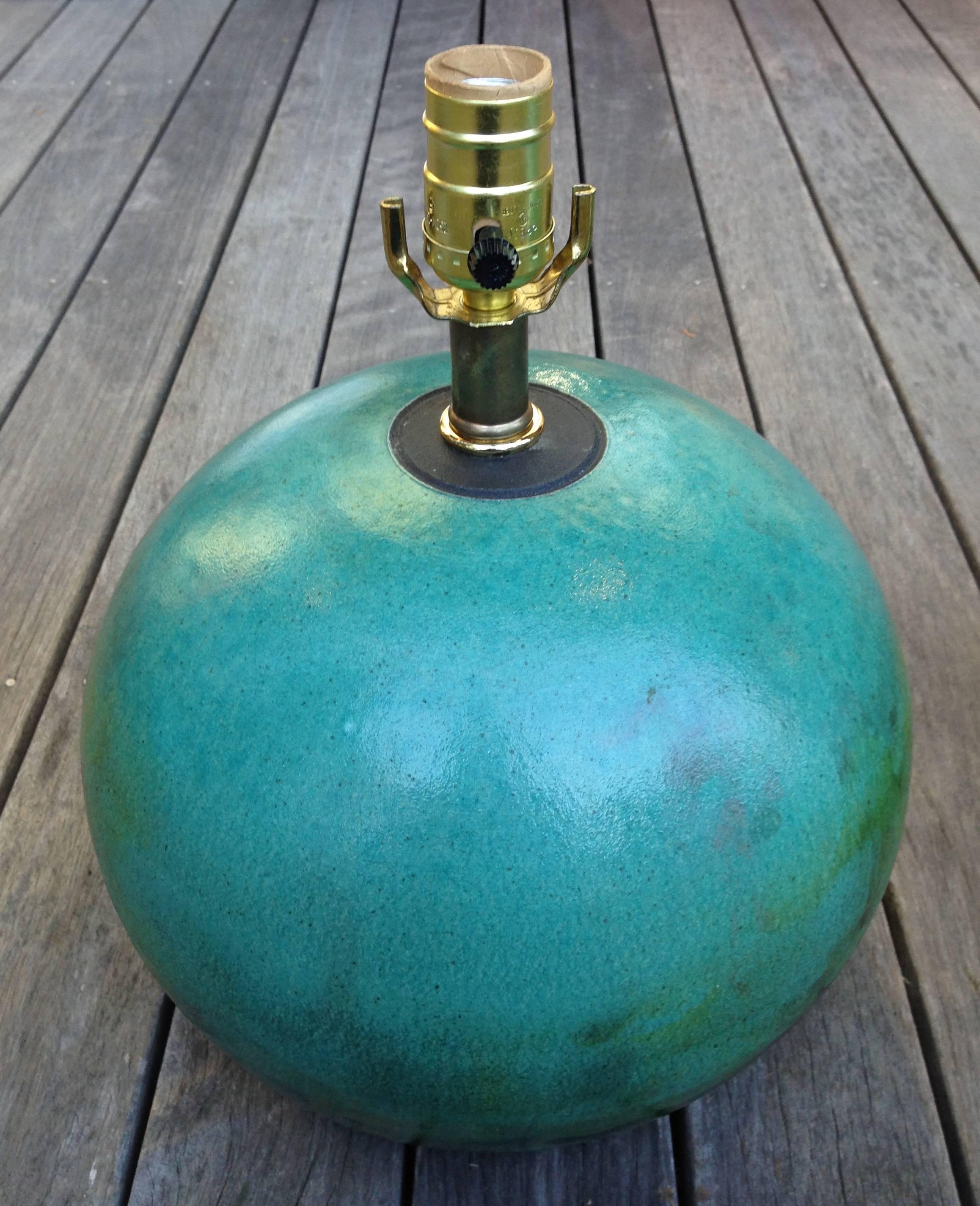 A pair of Raku pottery lamps in a vibrant sea foam green palette, late 20th century.

Measures: 11.5" W x 14" (top of socket) / 9" (top of sphere) H.