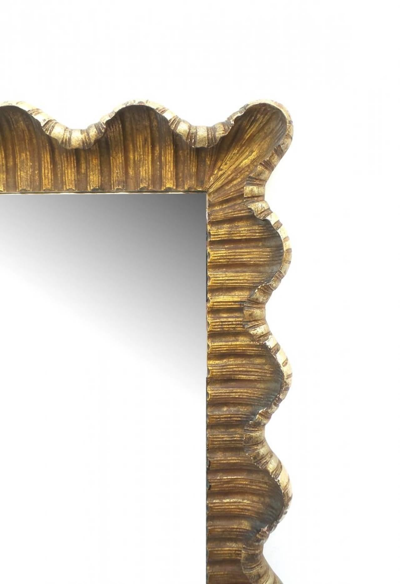 Large carved scallop form giltwood mirror, 1950s; Horizontal or vertical mounting.