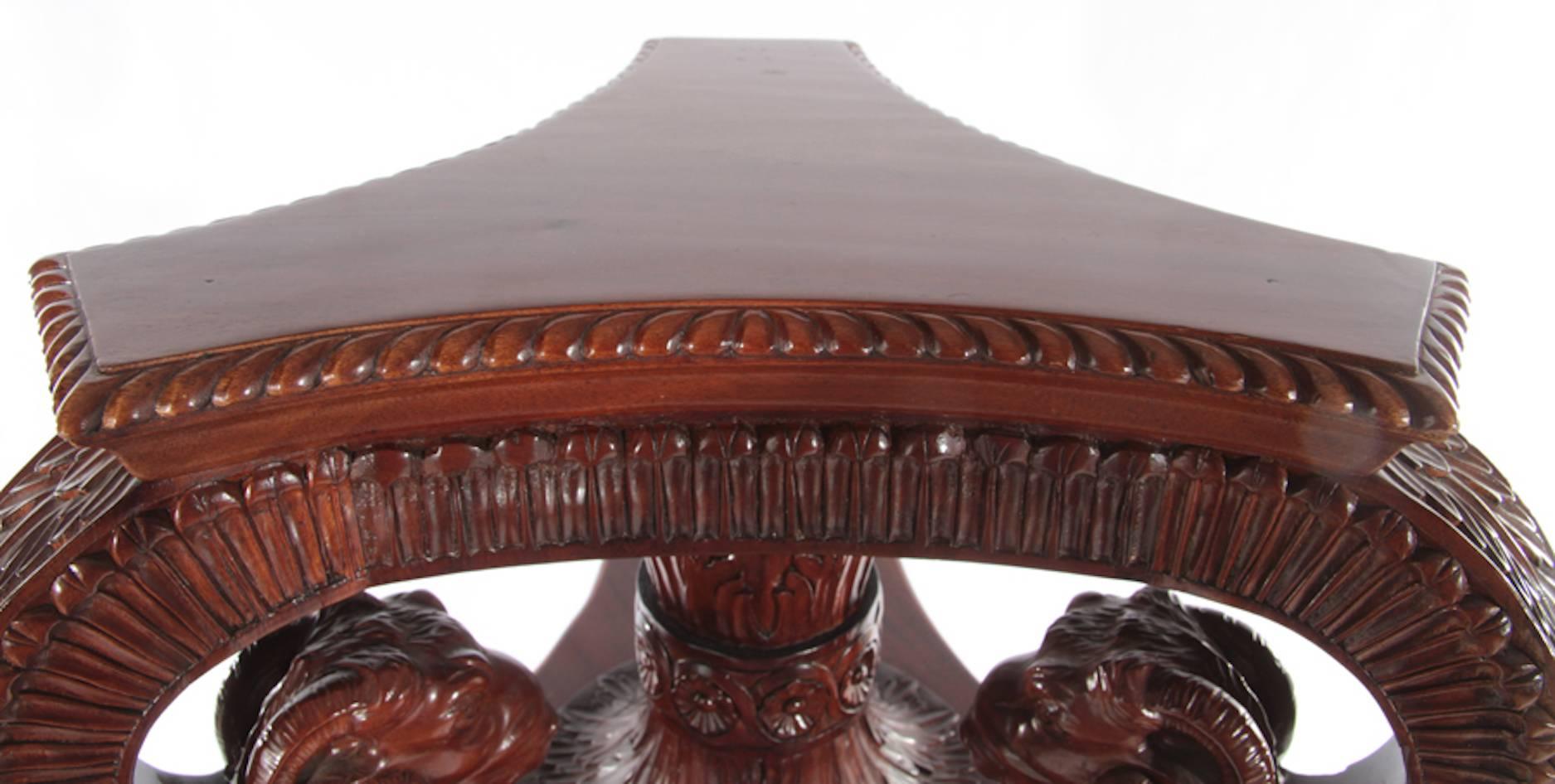 A carved mahogany athenienne or pedestal, ram's head supported top and hoofed feet, raised on a stepped base. Measures: Height 57.5