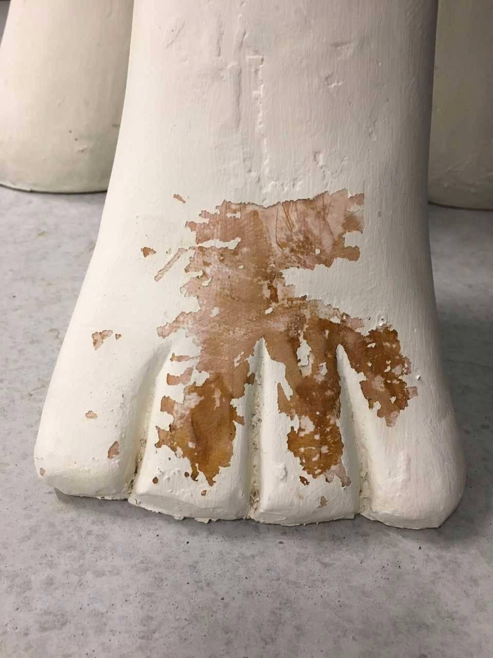 Plaster side table; round top, three stylized paw feet, 1970. Plaster was originally faux painted/ stained to resemble wood, and has been overlaid with white paint more recently.