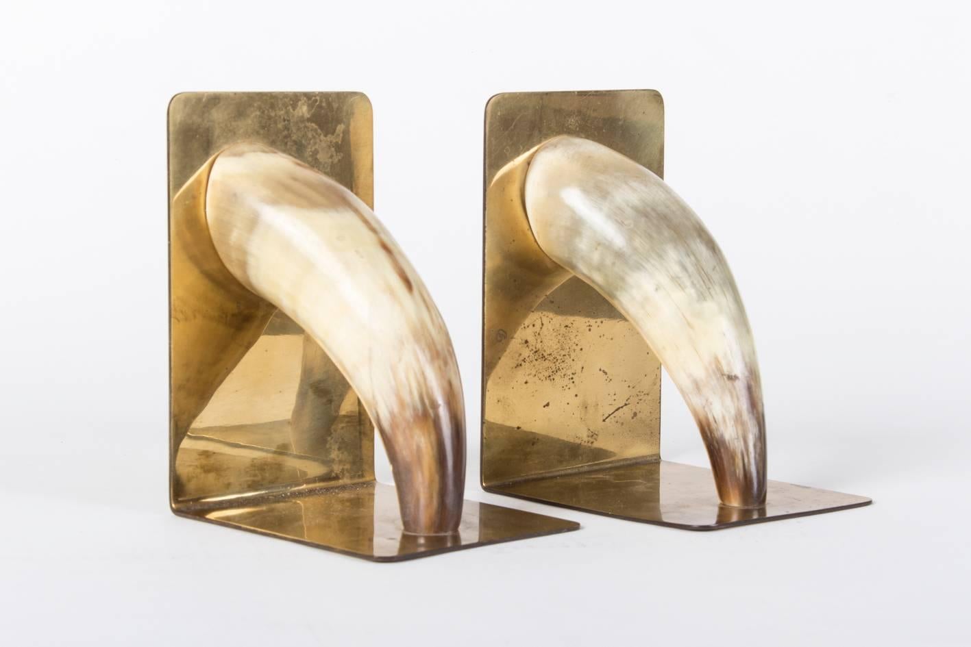Nice set of the well-known Auböck bookends, marked and made of brass and polished horn.