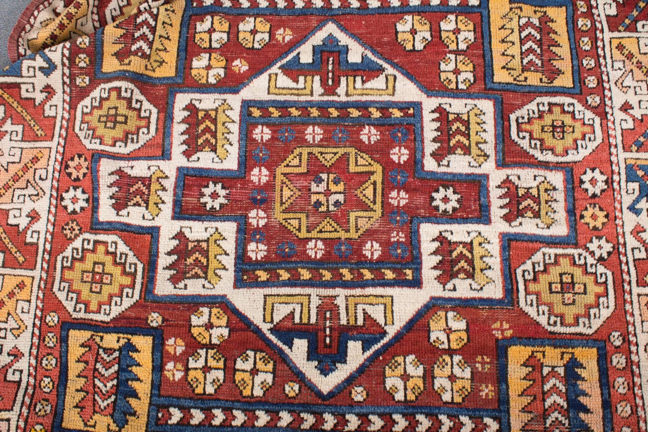 An unmistakable large and beautiful Bergama rug from the end of 19th century in his classical colors and structure with its white-ground border and midfield, typical for this region. Completely preserved piece with both original kilim