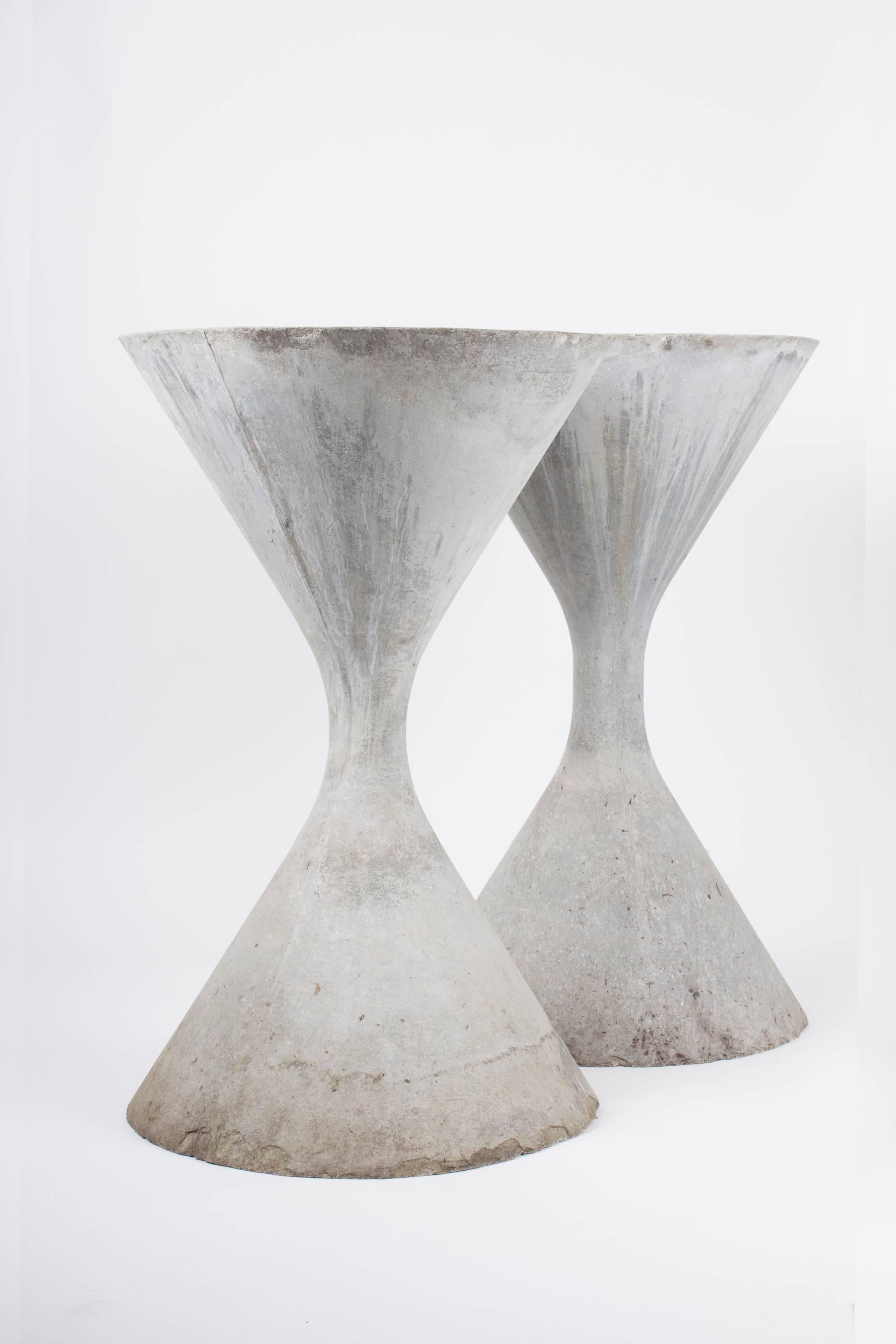 A fantastic pair of concrete hourglass or spindel planters by the Swiss Architect, Willy Guhl. 

Great age, patina and coloring. Iconic sculptural planter or garden object. Priced as a pair. Please find our other listings for Guhl planters as