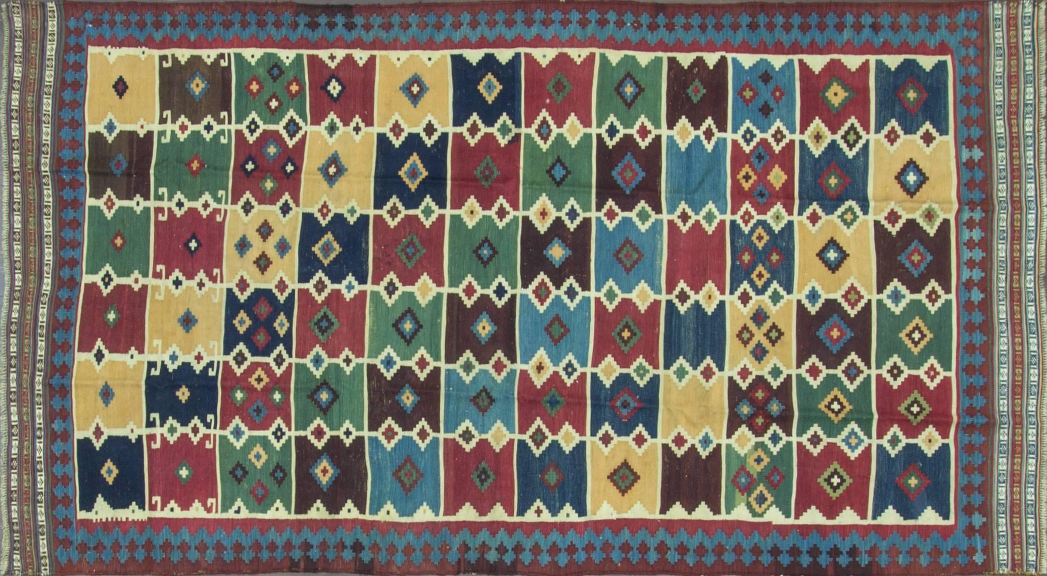 The polychrome field with horizontal bands of mustard, midnight blue, powder blue, green, and ivory rectangular motifs. In the 16th century the predecessors of the Qashqai were in what is now the Azerbaijan area, they were a group of Oguz/Seljuq