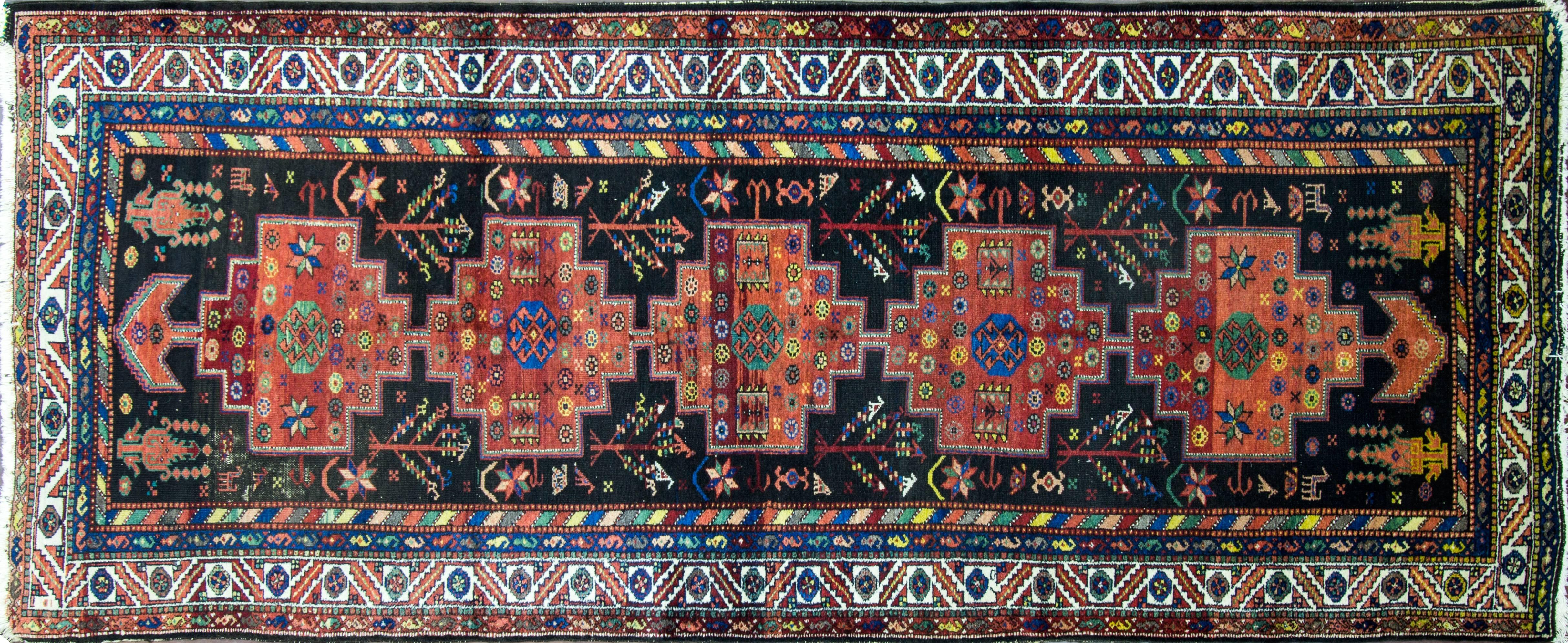 Earli circa 1900 Persian Bakhtiari tribal gallery size carpet with vegetable dyed wool, with multi-color on brown black background colors.
The design of the rug is three of life animals and geometric and floral motives. 
 The Bakhtiari tribe,