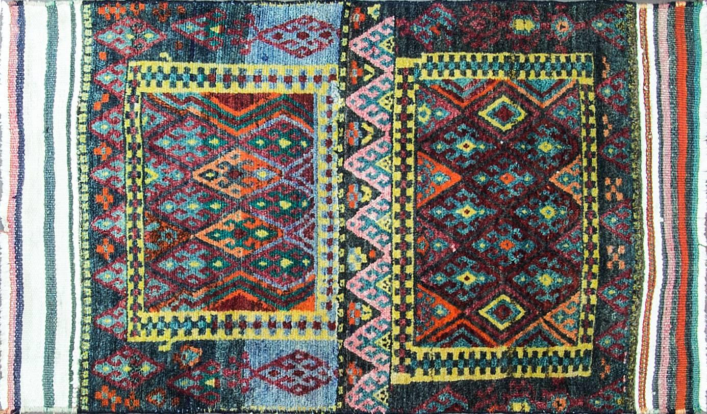 Kurdish weaving is its commitment to color. While a taste for rich color is by no means the private preserve of Kurdish weaving, it is difficult to find a Kurdish rug that does not have it.
 The design here draws equally on pile and Kilim