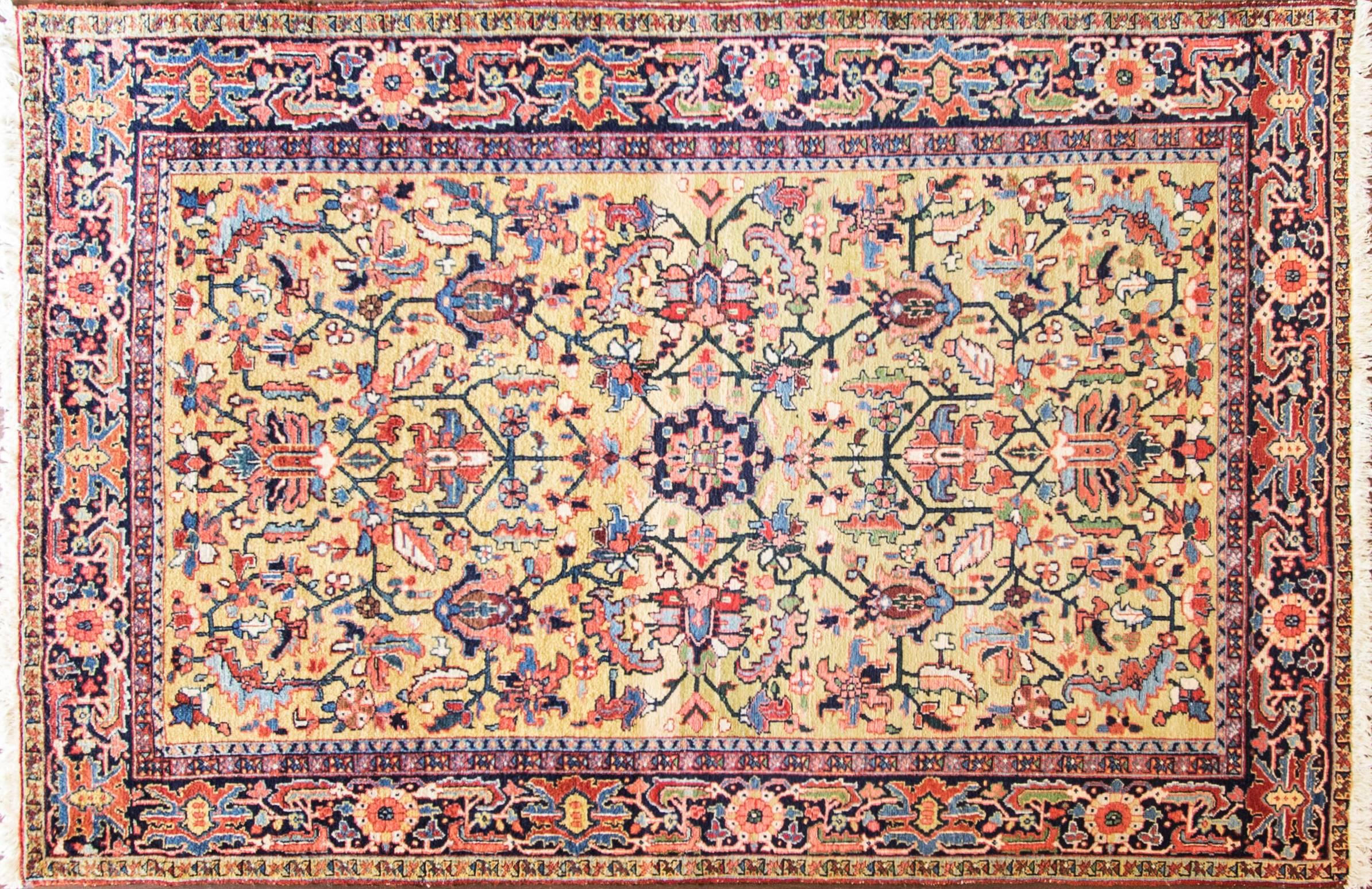 Gorgeous antique Persian Heriz carpet with all-over design and breathtaking goldish green background. Heriz rugs are Persian rugs from the area of Heris, East Azerbaijan in northwest Iran, northeast of Tabriz. Such rugs are produced in the village