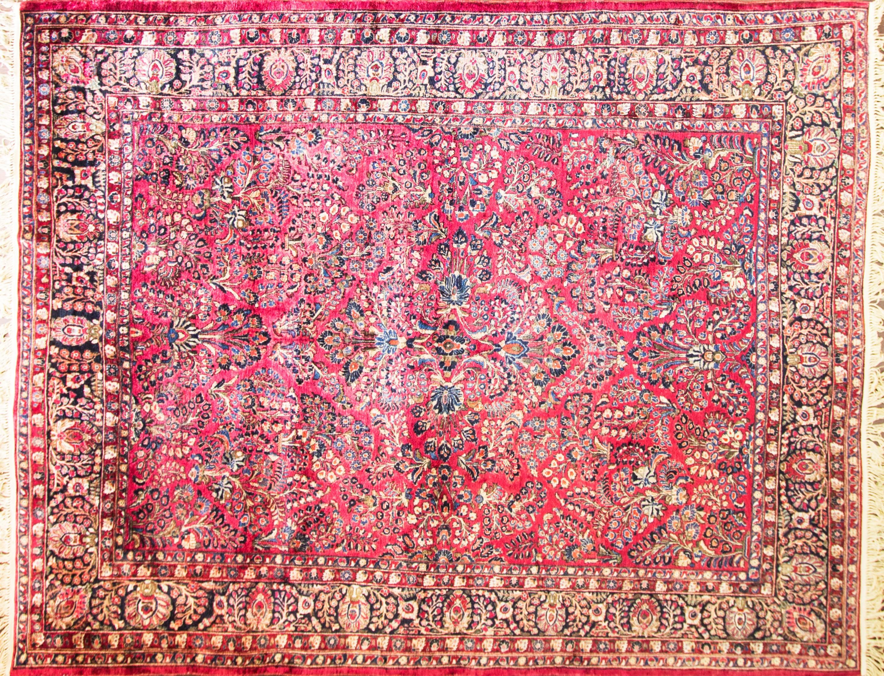 This is an authentic handmade rug. It was made in Persia around the 1920s or before. The design is overall floral motives, garden design. The overall color pallet is red blue tones with green black and yellow. 
 
 The materials are wool pile with