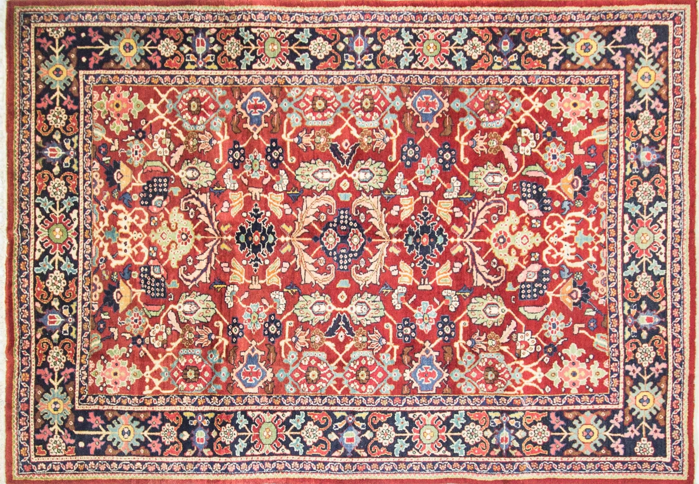 This is an authentic handmade rug. It was made in Persia, circa 1940s or before. 
 
 The materials are wool pile with cotton foundation. The colors are from vegetable dyes, and the general pattern is geometric and floral design inside two