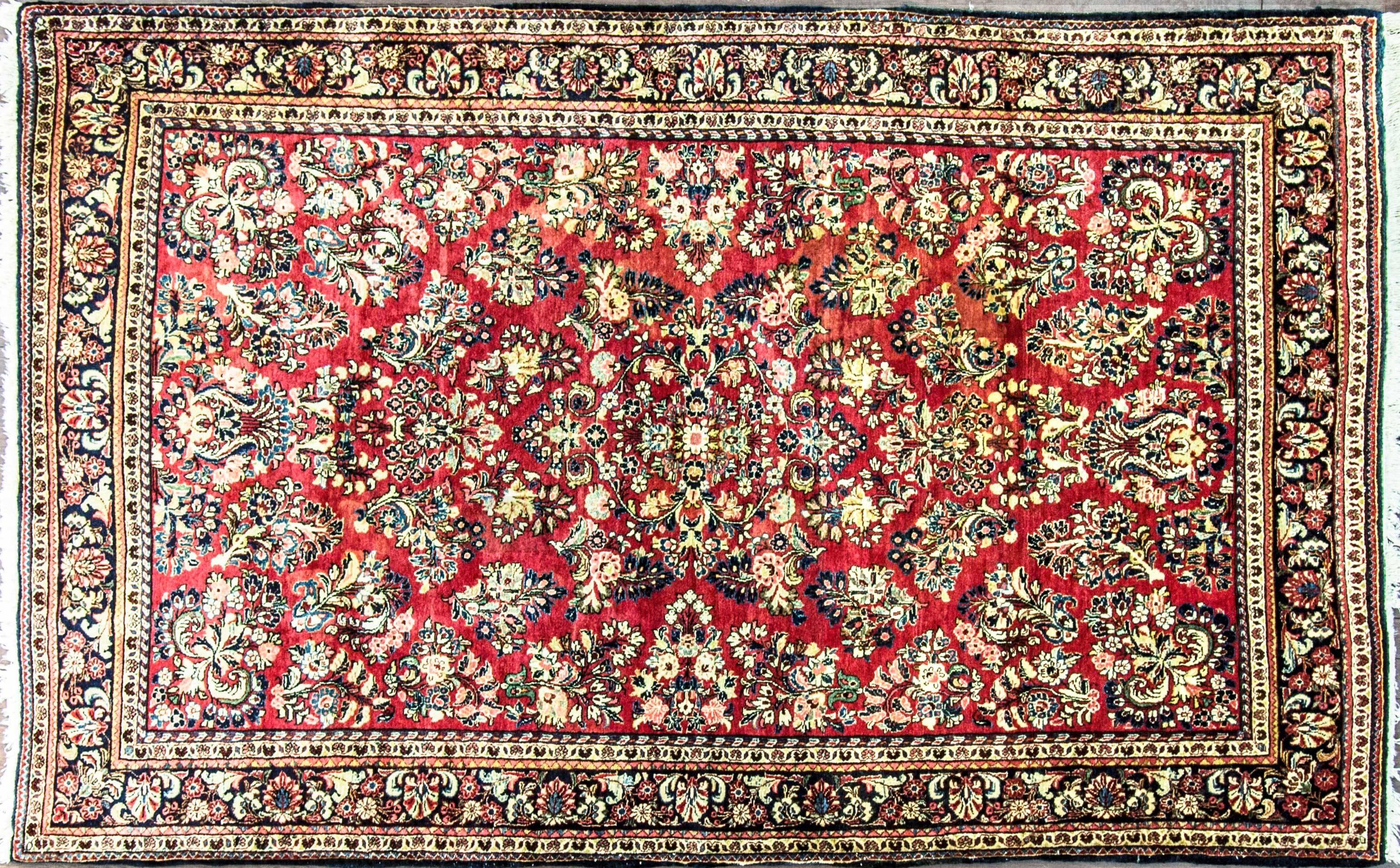 Persian Sarouk rug, circa 1930, Very fine and soft vegetable dye wool (not painted Sarouk) very high density of knots in excellent condition. A nice soft tone of red and blue background colors with symmetrical floral pattern.

 The materials are