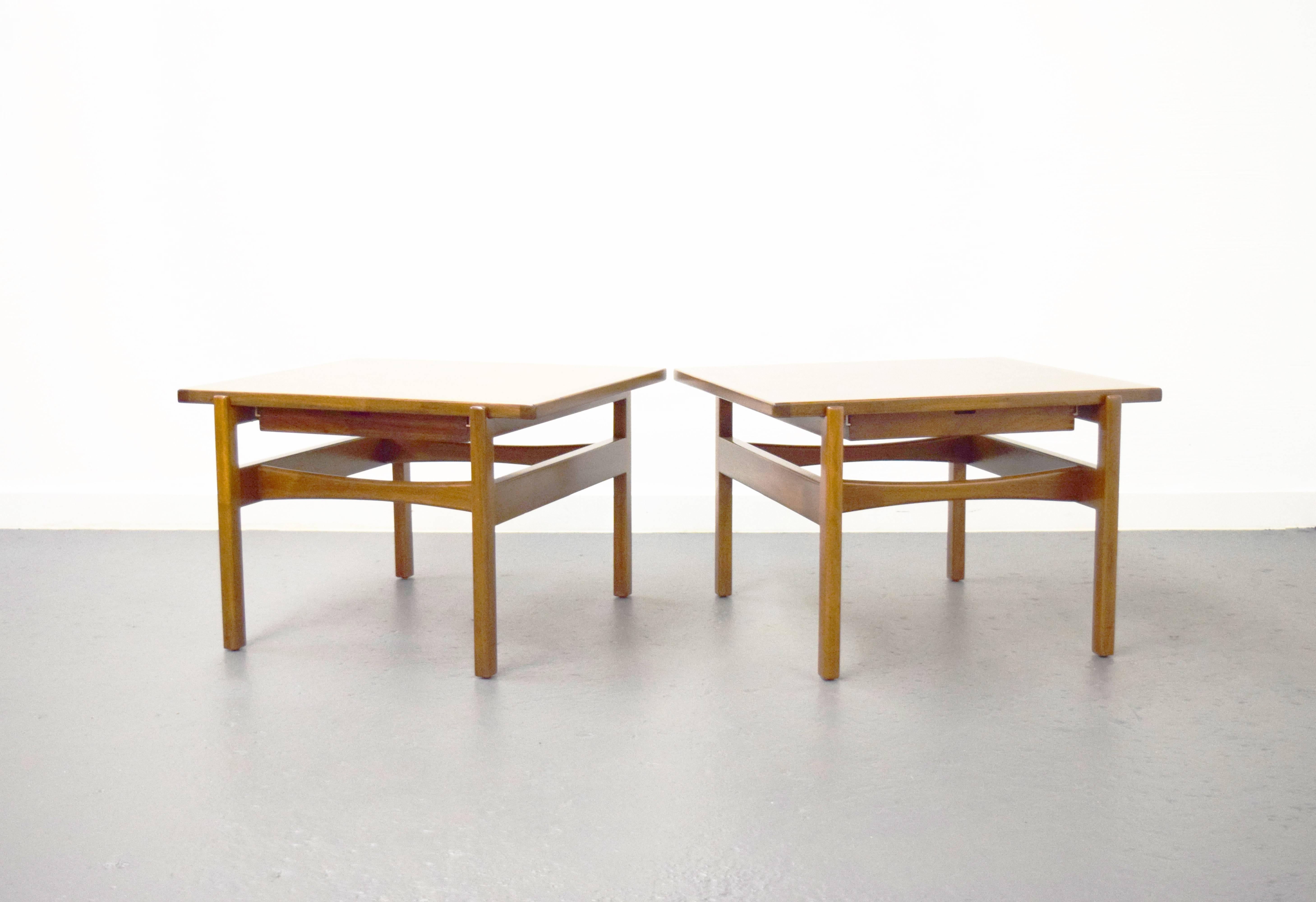 Pair of Jens Risom end / side tables. Surface floats on sculptural frame. Hidden drawer with dovetailing detail.