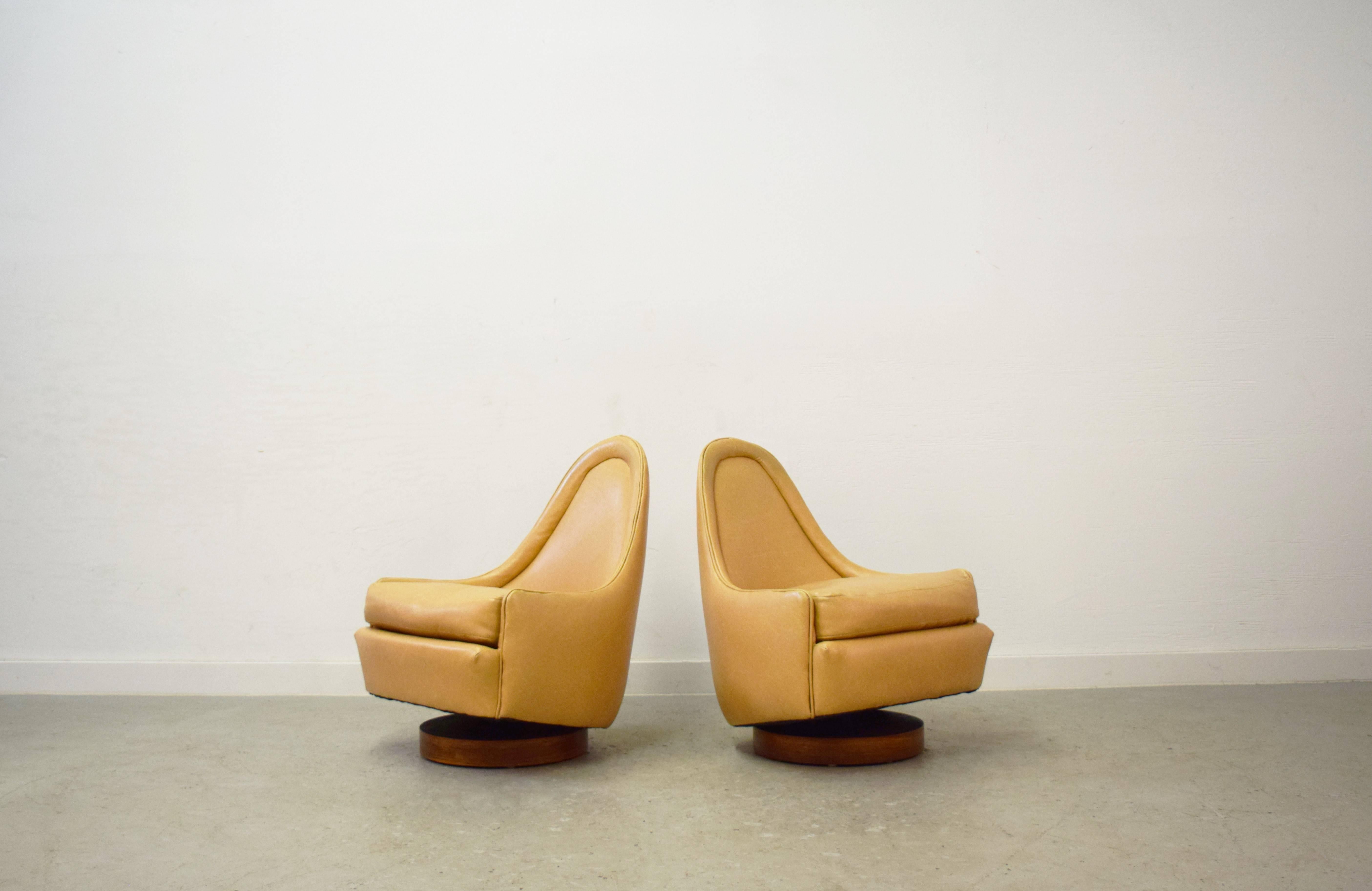 Pair of petite swivel slipper lounge chairs by Milo Baughman.