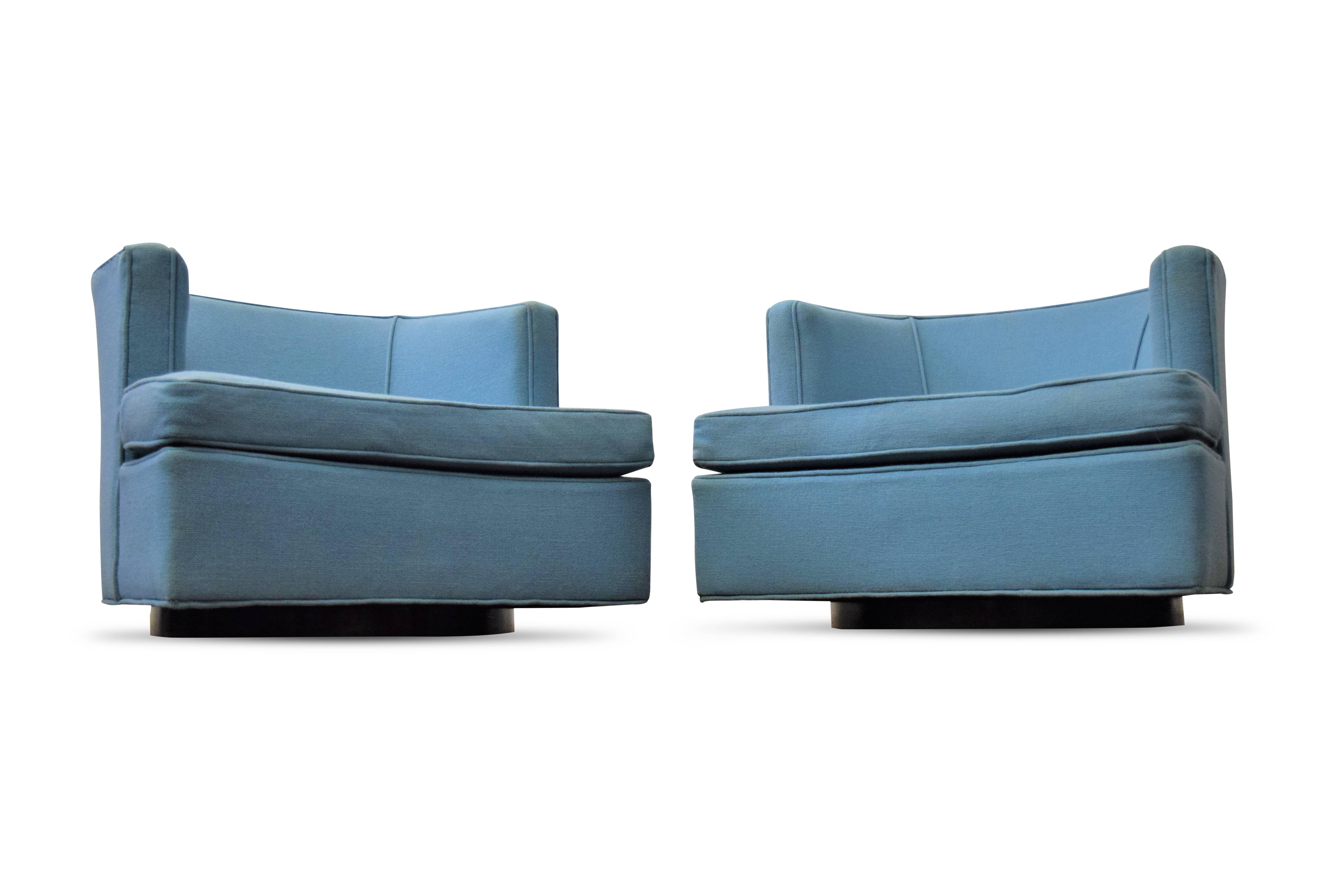 Pair of Harvey Probber swivel lounge chairs. Chairs sit on round dark walnut wooden bases.