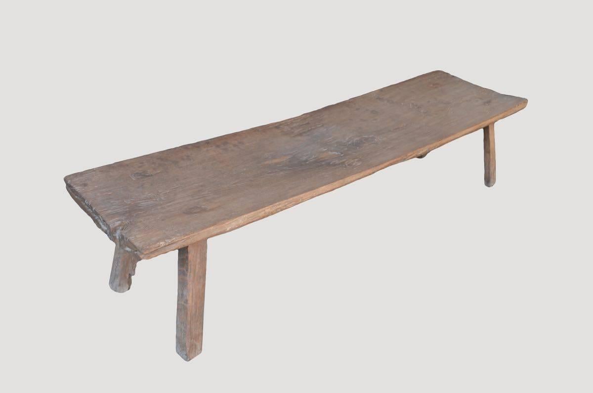 Antique Primitive bench. Carved from a single piece of aged teak wood. This beautiful single slab has amazing natural patina.

This bench was sourced in the spirit of wabi-sabi, a Japanese philosophy that beauty can be found in imperfection and