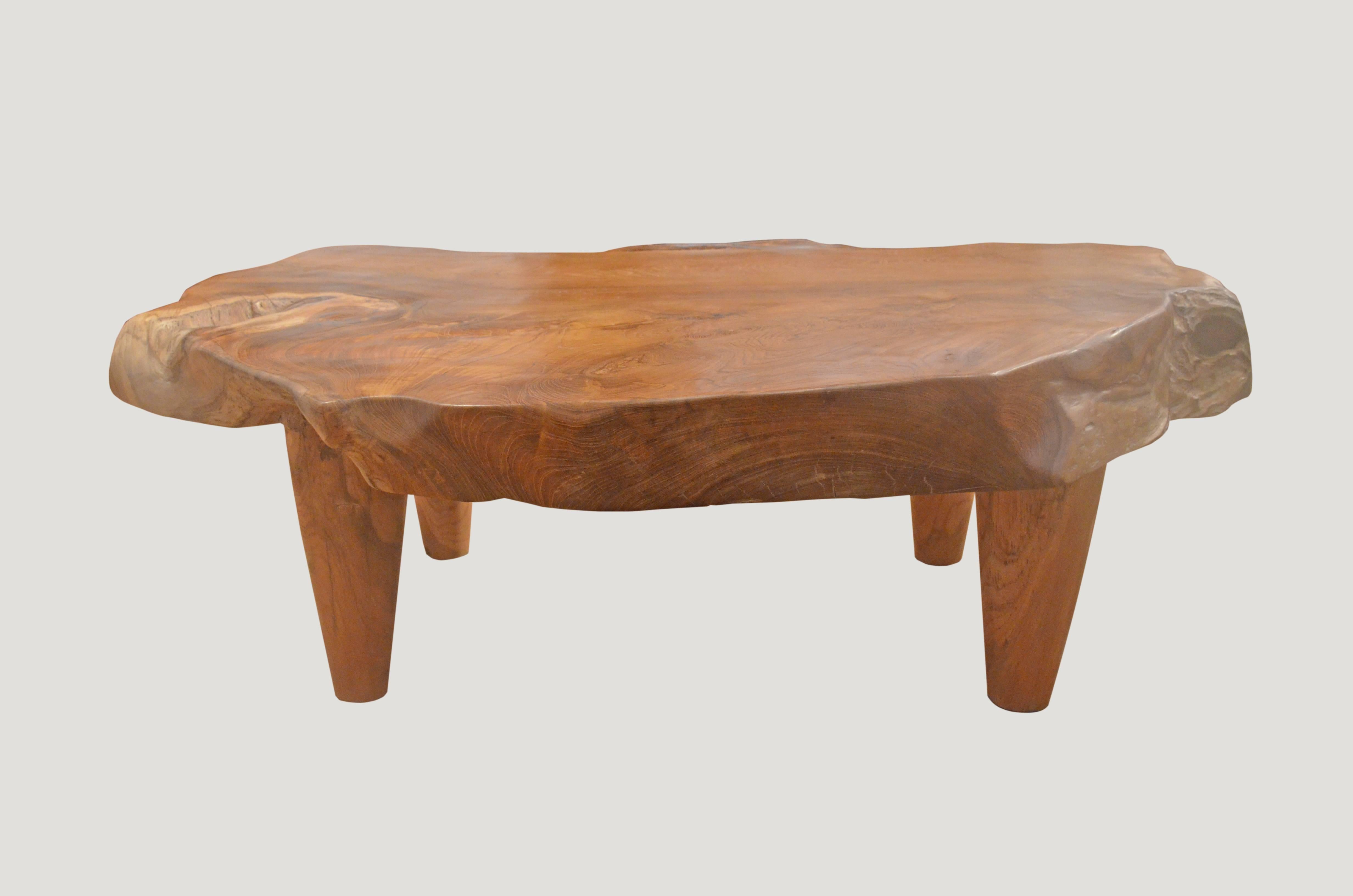 Impressive single reclaimed teak wood slab coffee table. Set on modern teak legs allowing the top to float.
