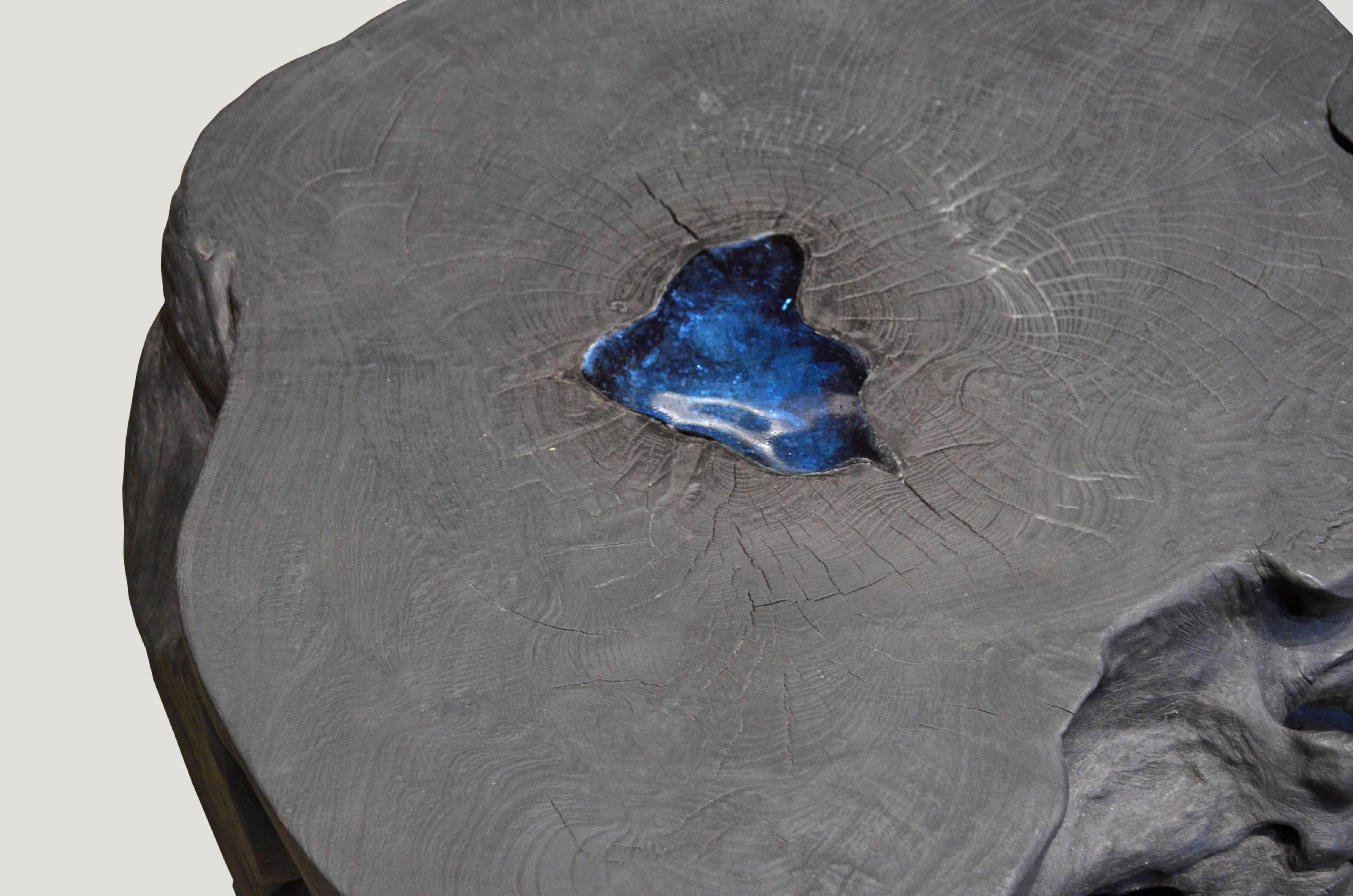 Organic shaped reclaimed teak wood coffee or side table with indigo cracked resin. Burnt, sanded and sealed with a drop of indigo resin in the natural groove of the wood. You saw it here first! Organic is the new modern.

The triple burnt collection