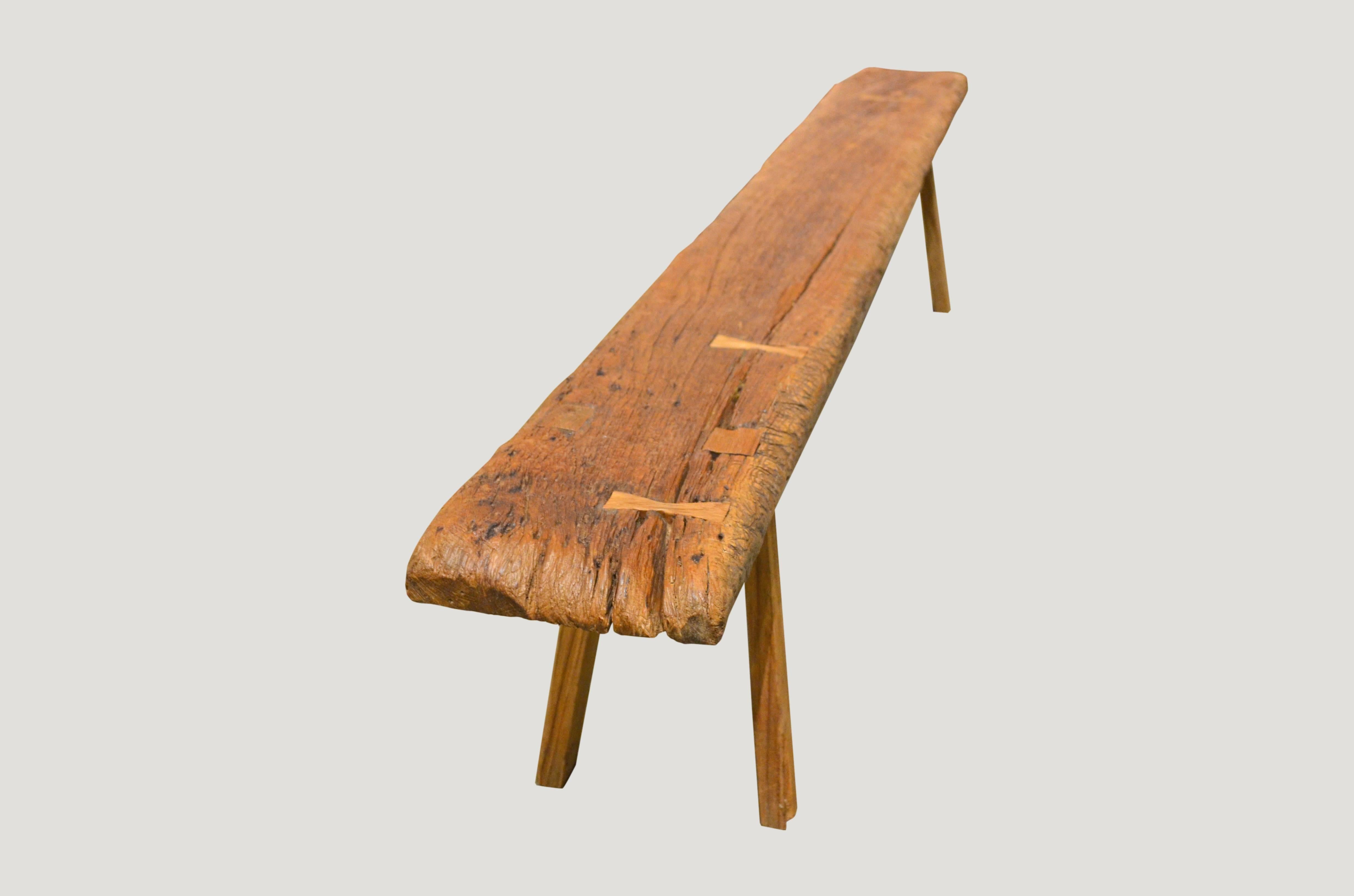 Antique single slab teak wood bench or coffee table with beautiful patina and added butterfly detail. Can also be used as a shelf.

This bench was sourced in the spirit of wabi-sabi, a Japanese philosophy that beauty can be found in imperfection