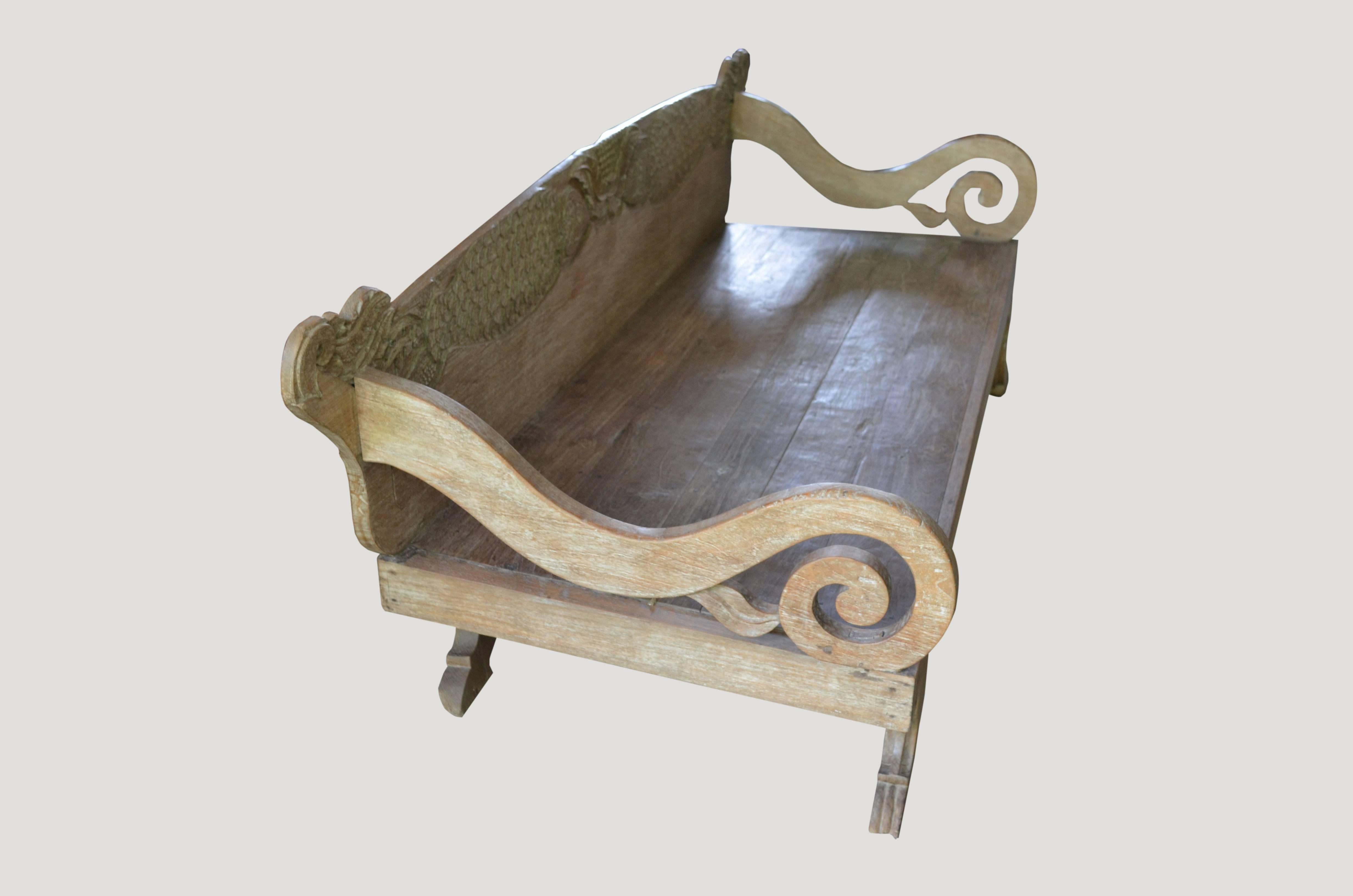 Rare Andrianna Shamaris teak wood daybed with hand-carved fish motif backrest and beautiful hand-carved legs. For the Primitive collector. This teak wood daybed comes with a white cotton mattress. Perfect for inside or outside relaxation.

This