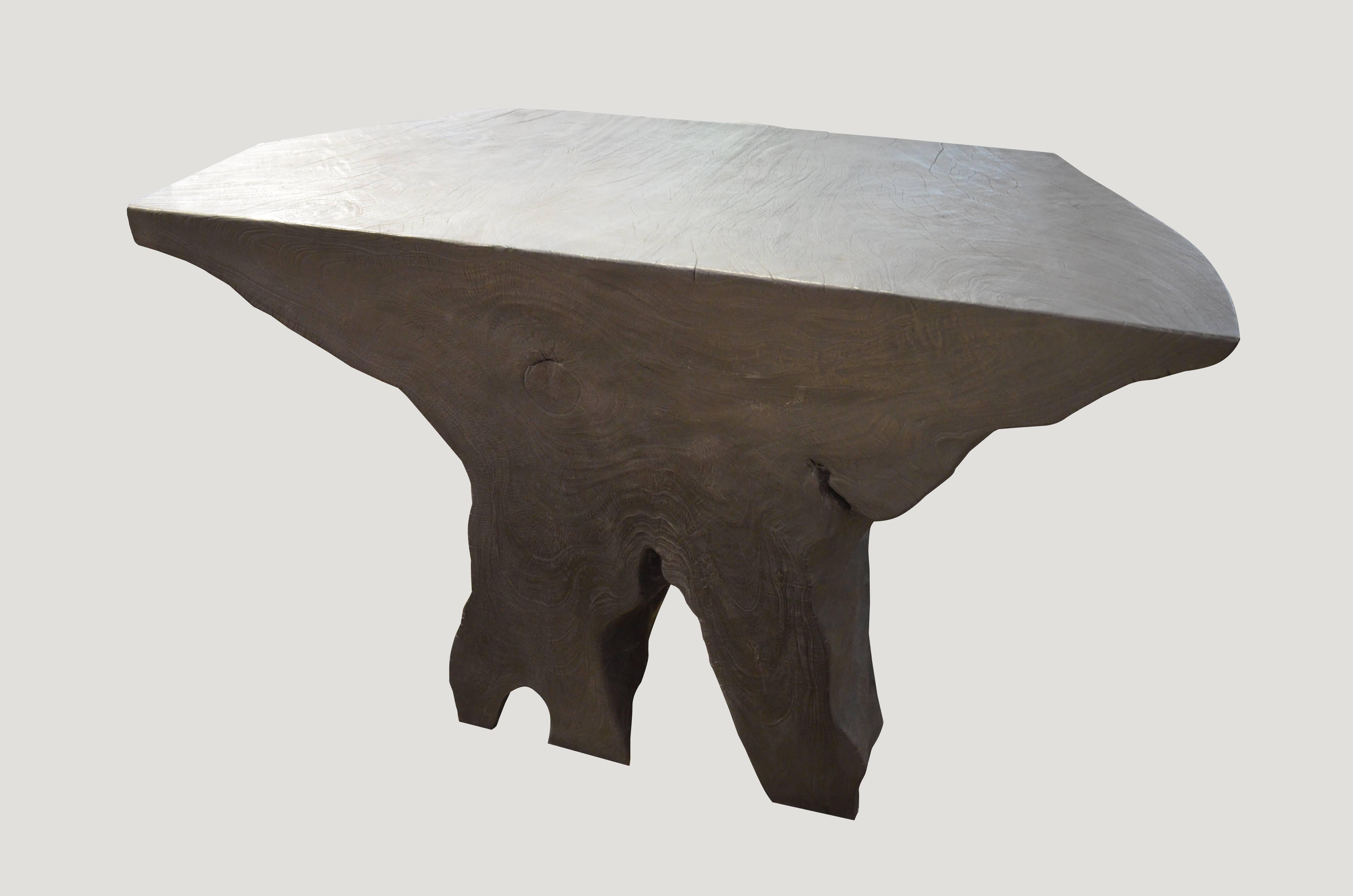 Impressive single reclaimed mahoni wood root, carved into a stunning organic shaped console which can also be turned and used as a coffee table.

The Triple Burnt Ccllection represents a unique line of modern furniture made from solid organic