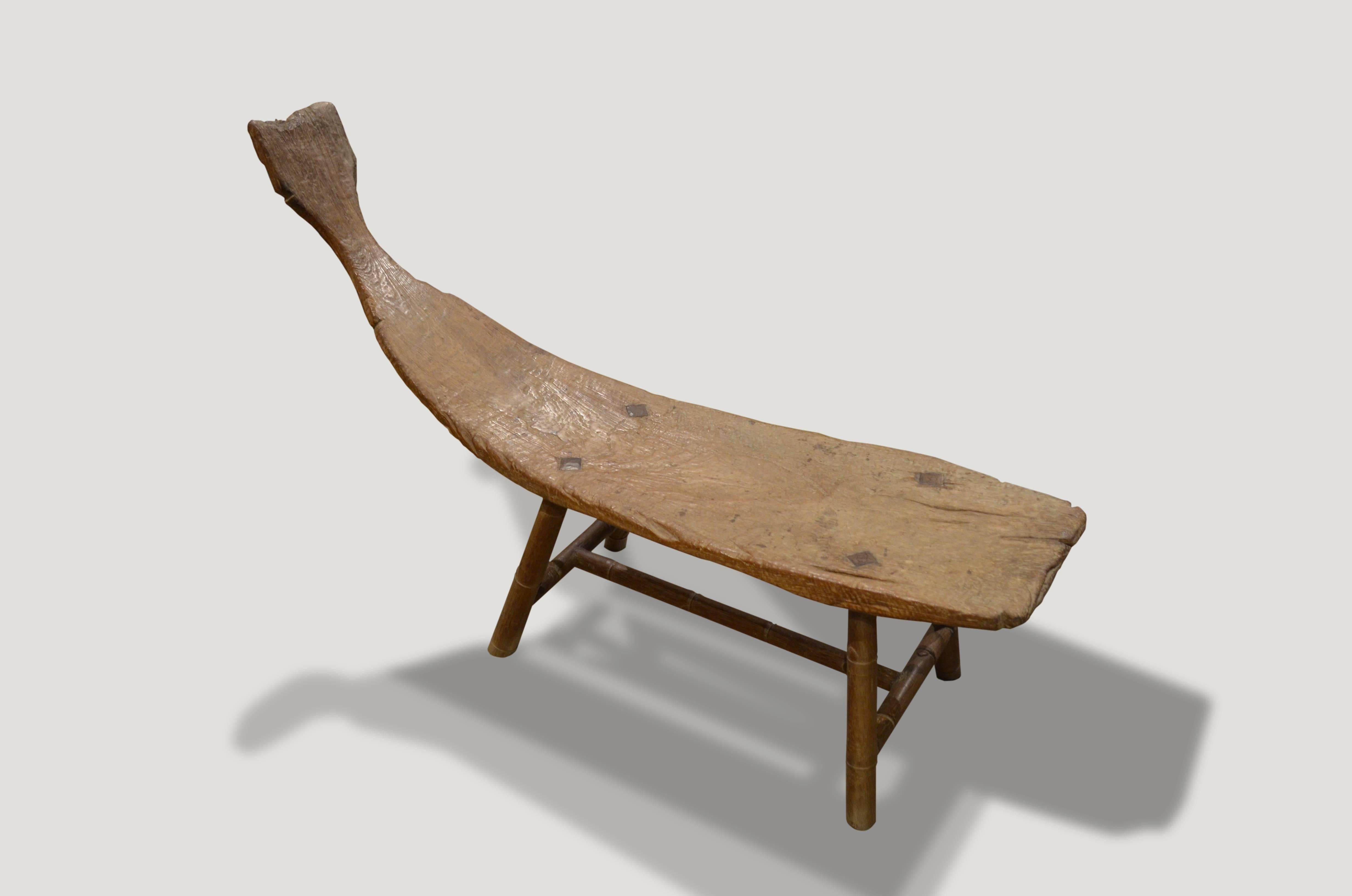 For the primitive collector. This stunning bench is hand-carved from a single teakwood root from Madura. Beautiful antique bamboo legs in contrast. Rare.

This bench was sourced in the spirit of wabi-sabi, a Japanese philosophy that beauty can be