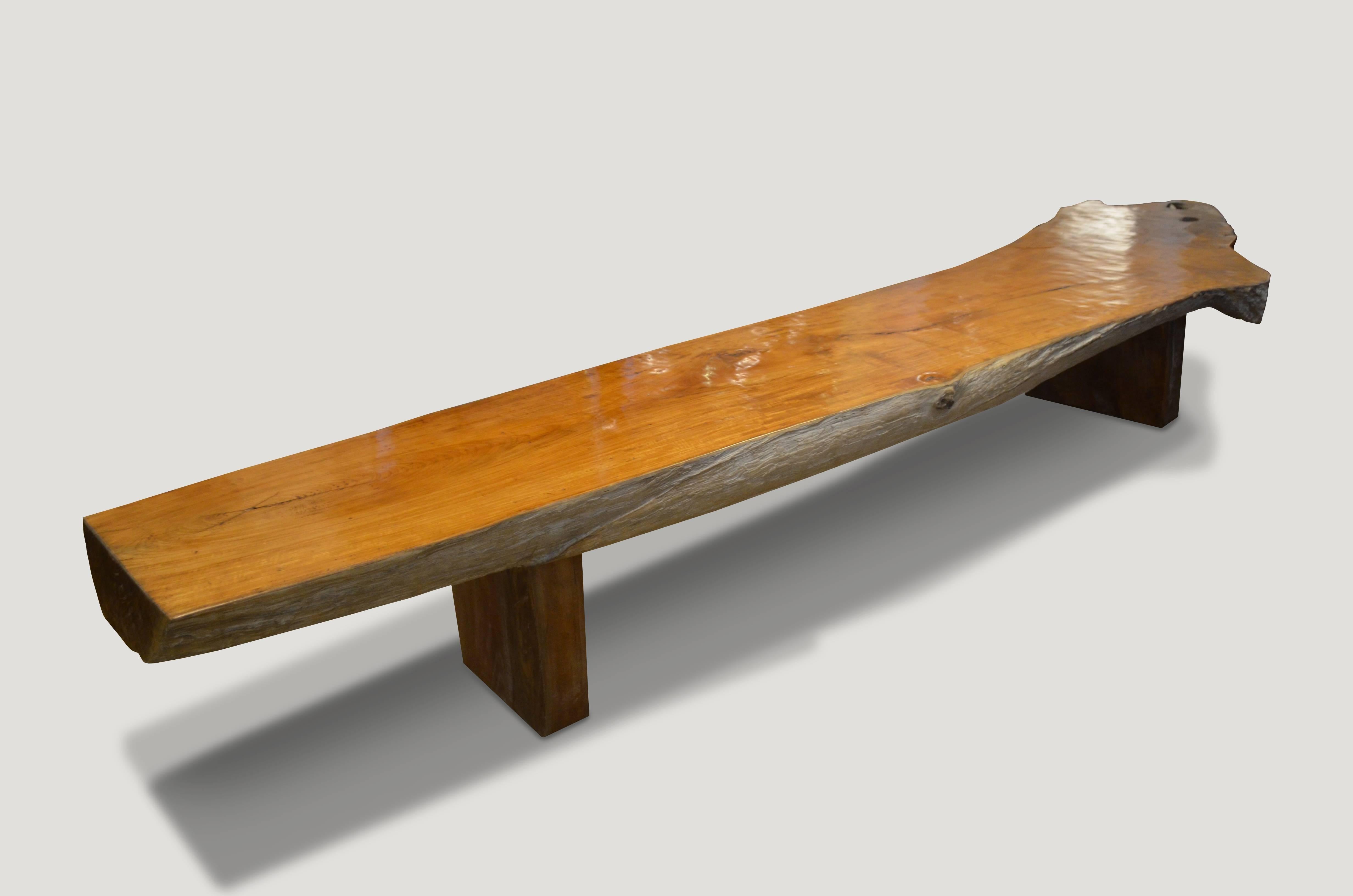 Impressive 4” single teak wood slab coffee table or bench. We have added modern Minimalist legs to this stunning organic shape. The top was polished to enhance the stunning grain in the reclaimed teak wood, whilst leaving the sides raw in contrast.