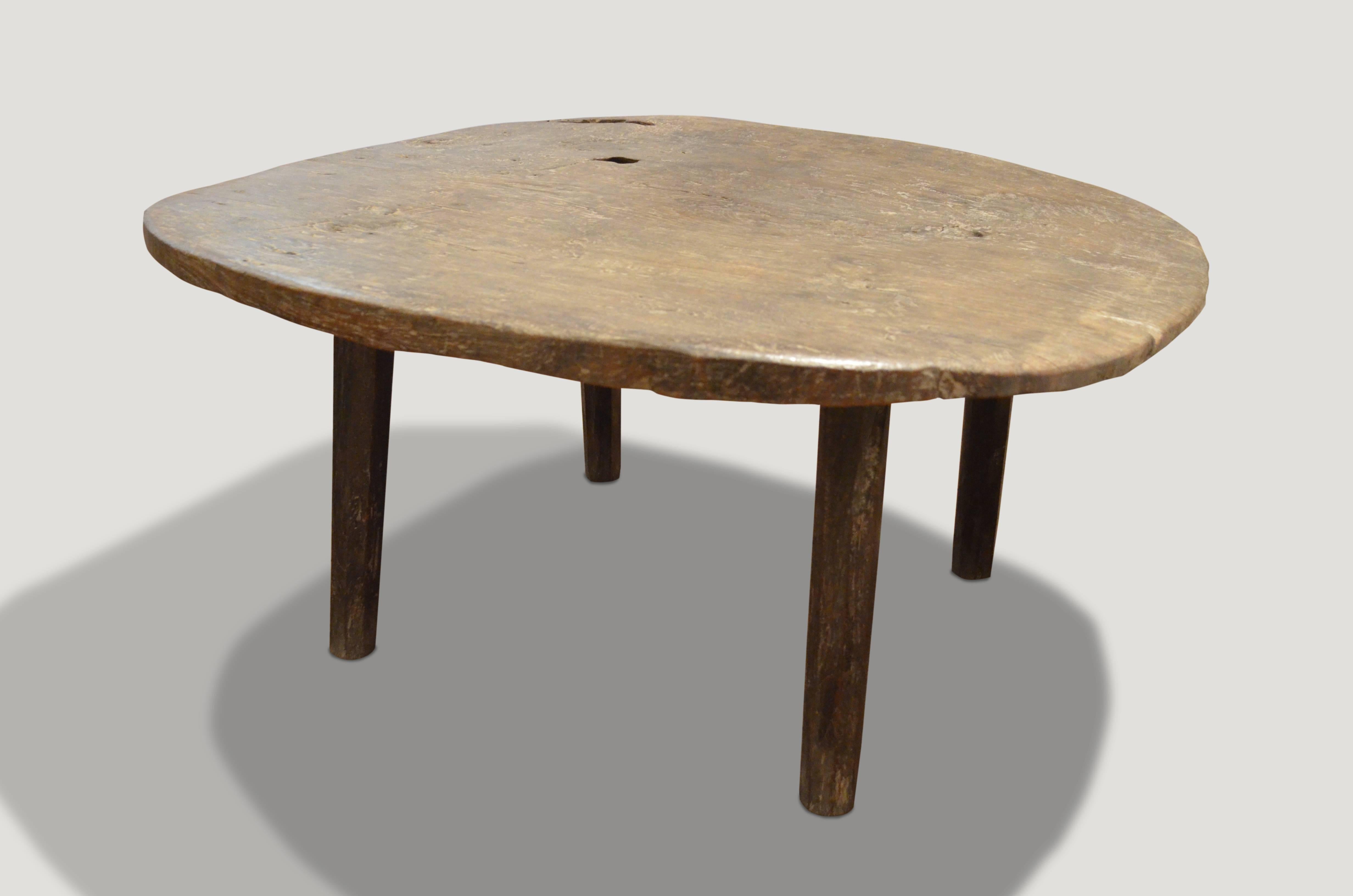 Unique single teak wood slab coffee table with beautiful patina. This coffee table has hand-carved bevelled legs with a hand-carved top with impressive scale. We can reduce the height if preferred.

This coffee table was sourced in the spirit of