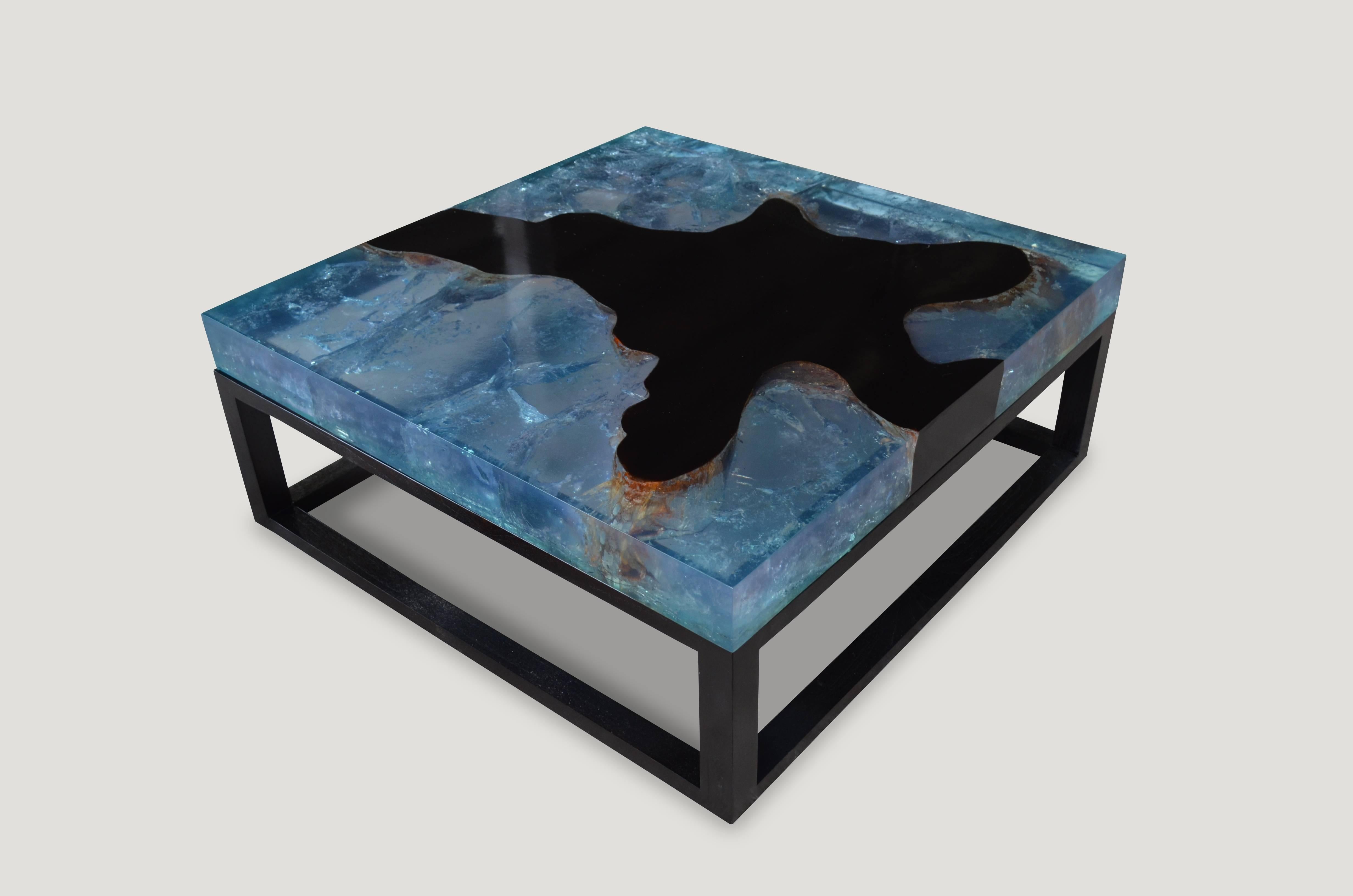 The cracked resin coffee table is made from teak wood infused with resin. A dramatic piece due to the four inch depth of the resin, which resembles a unique quartz crystal with many different facets. An impressive addition to any space. Currently a